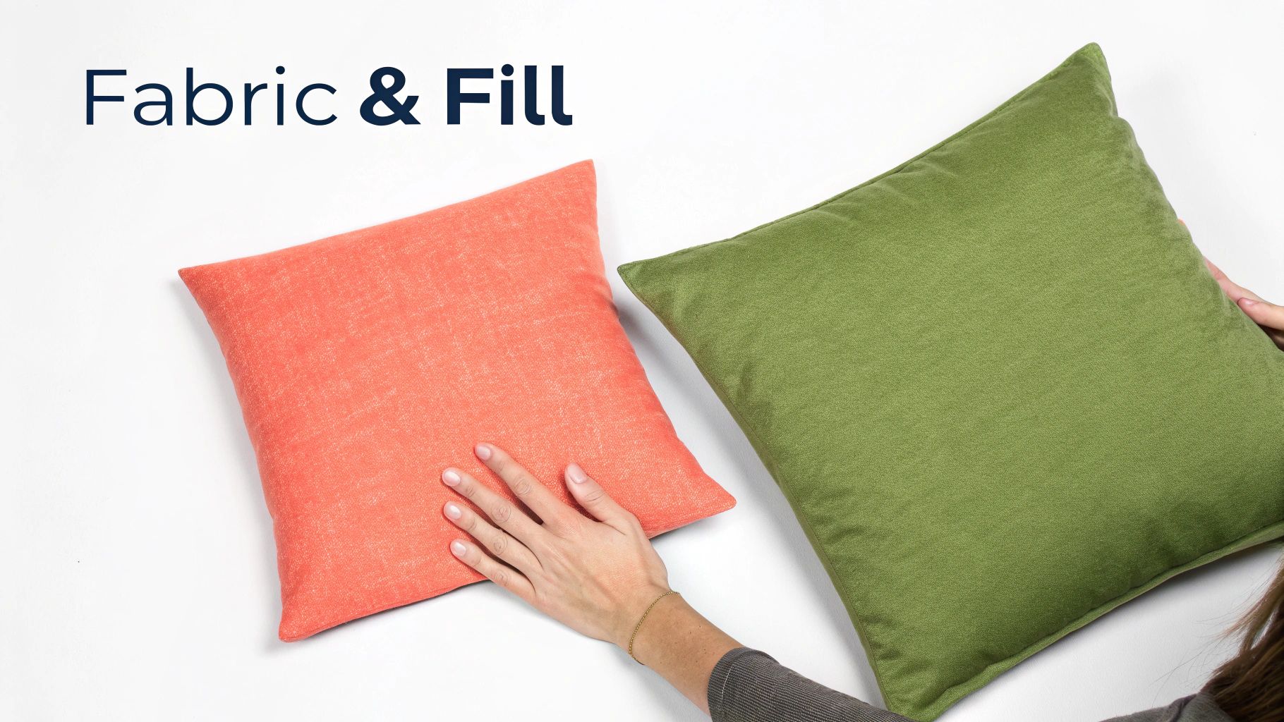 Two decorative throw pillows in coral and olive green colors with hands demonstrating fabric and fill quality