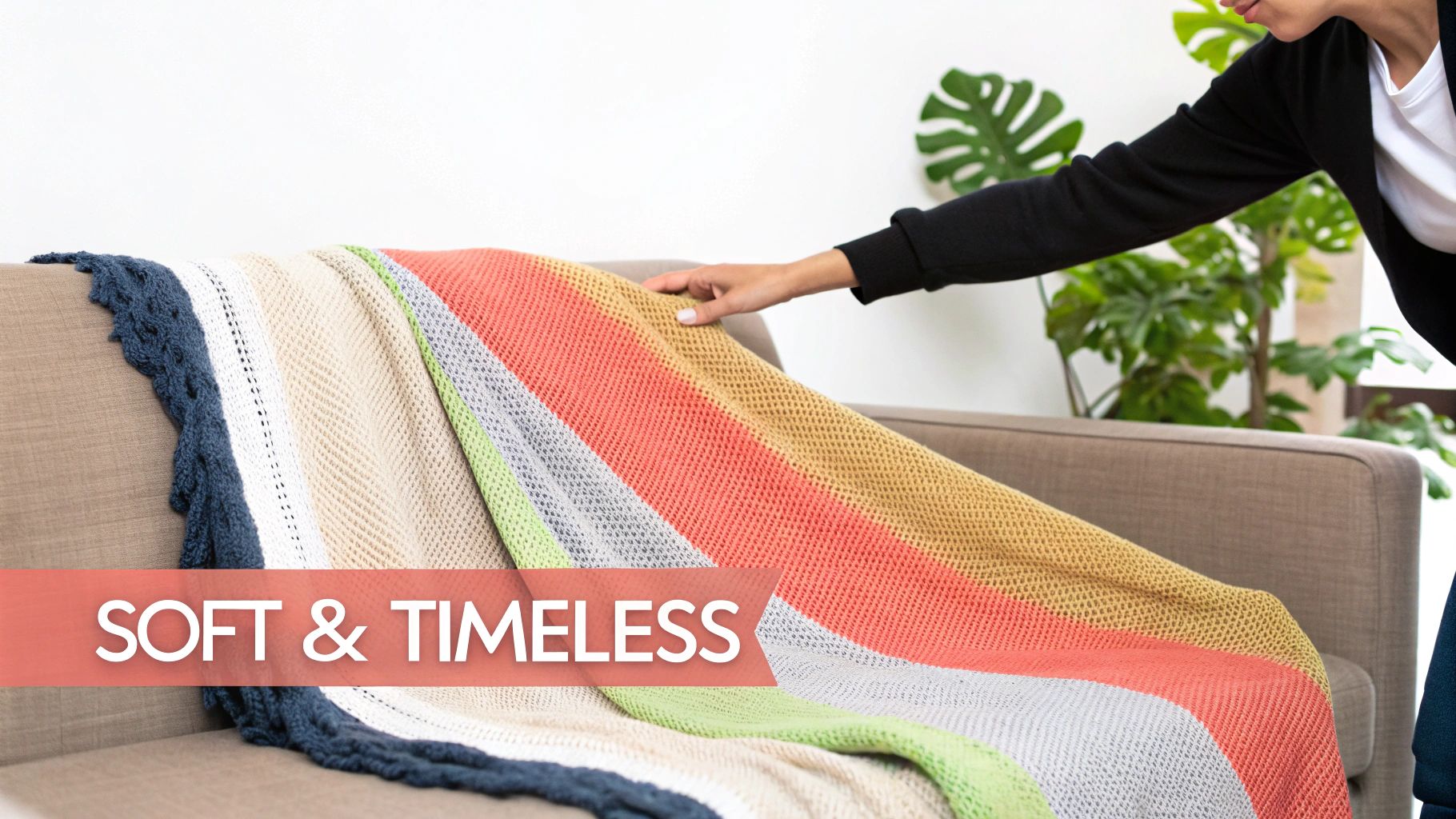 A person's hand gently touches a soft, colorful knitted blanket draped over a brown sofa, with text "SOFT & TIMELESS".