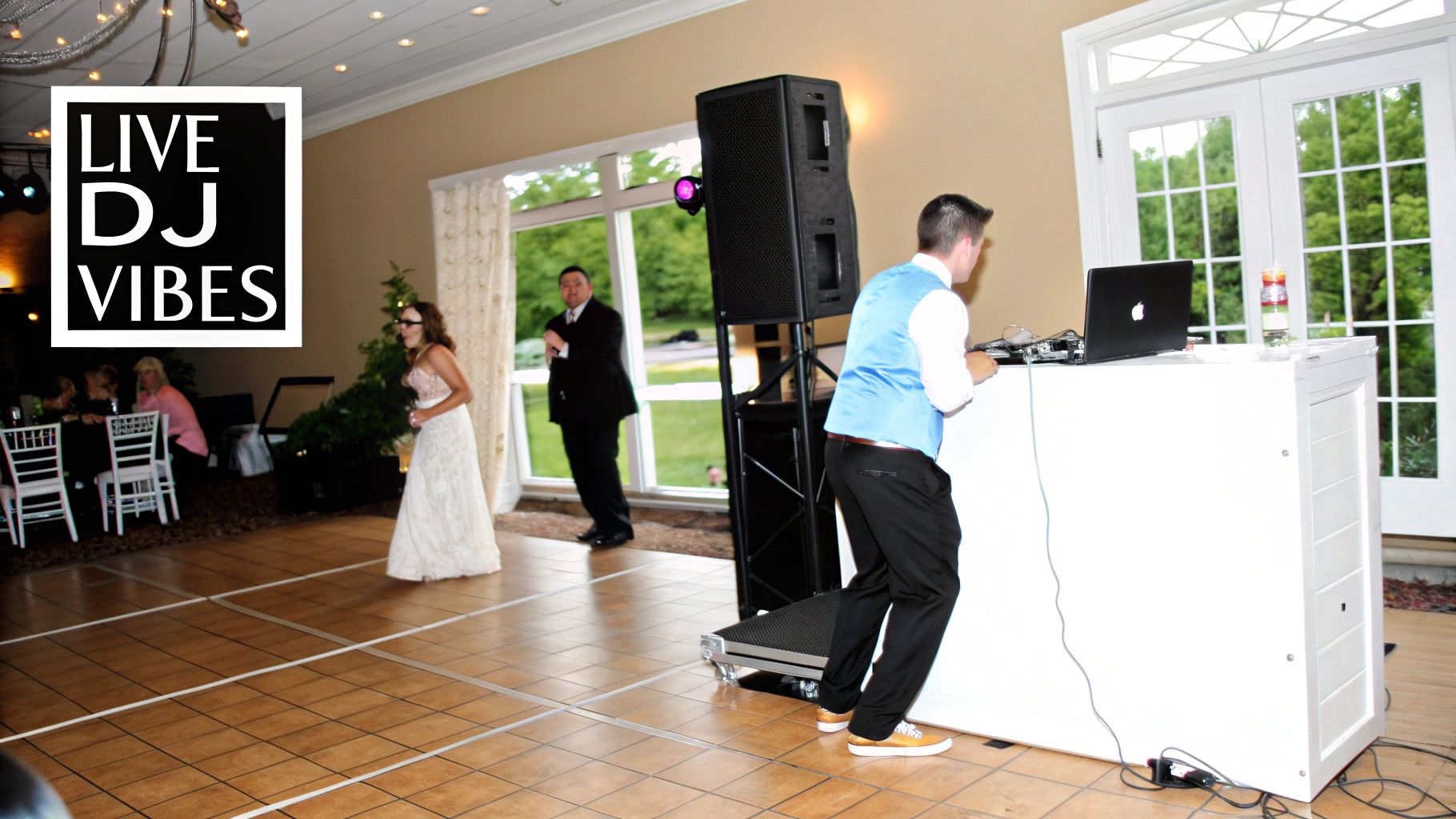 A vibrant wedding reception features a DJ playing music and guests enjoying the dance floor.