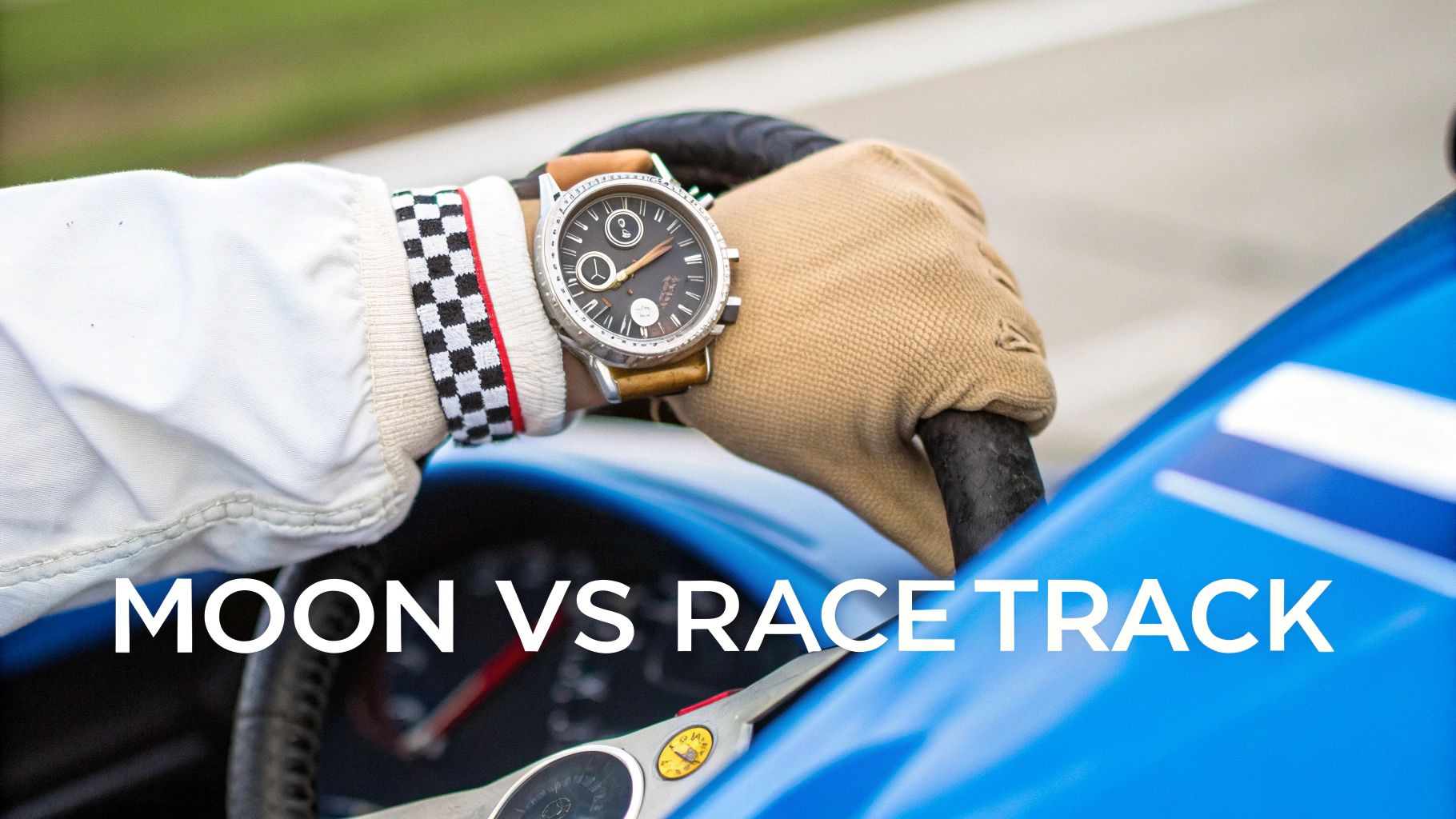 Close-up of a person's wrist with a watch, wearing a racing suit and glove, gripping a steering wheel.