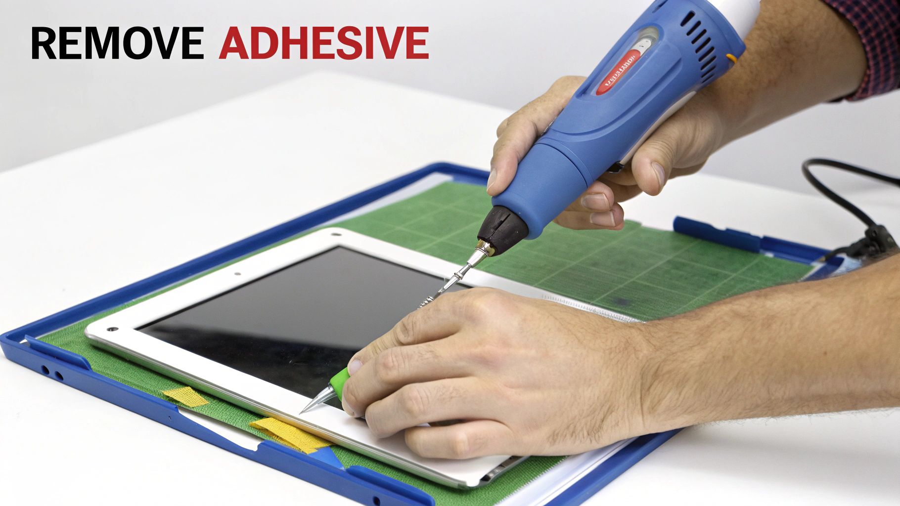 A technician carefully removing old adhesive from a smartphone frame with a plastic tool.