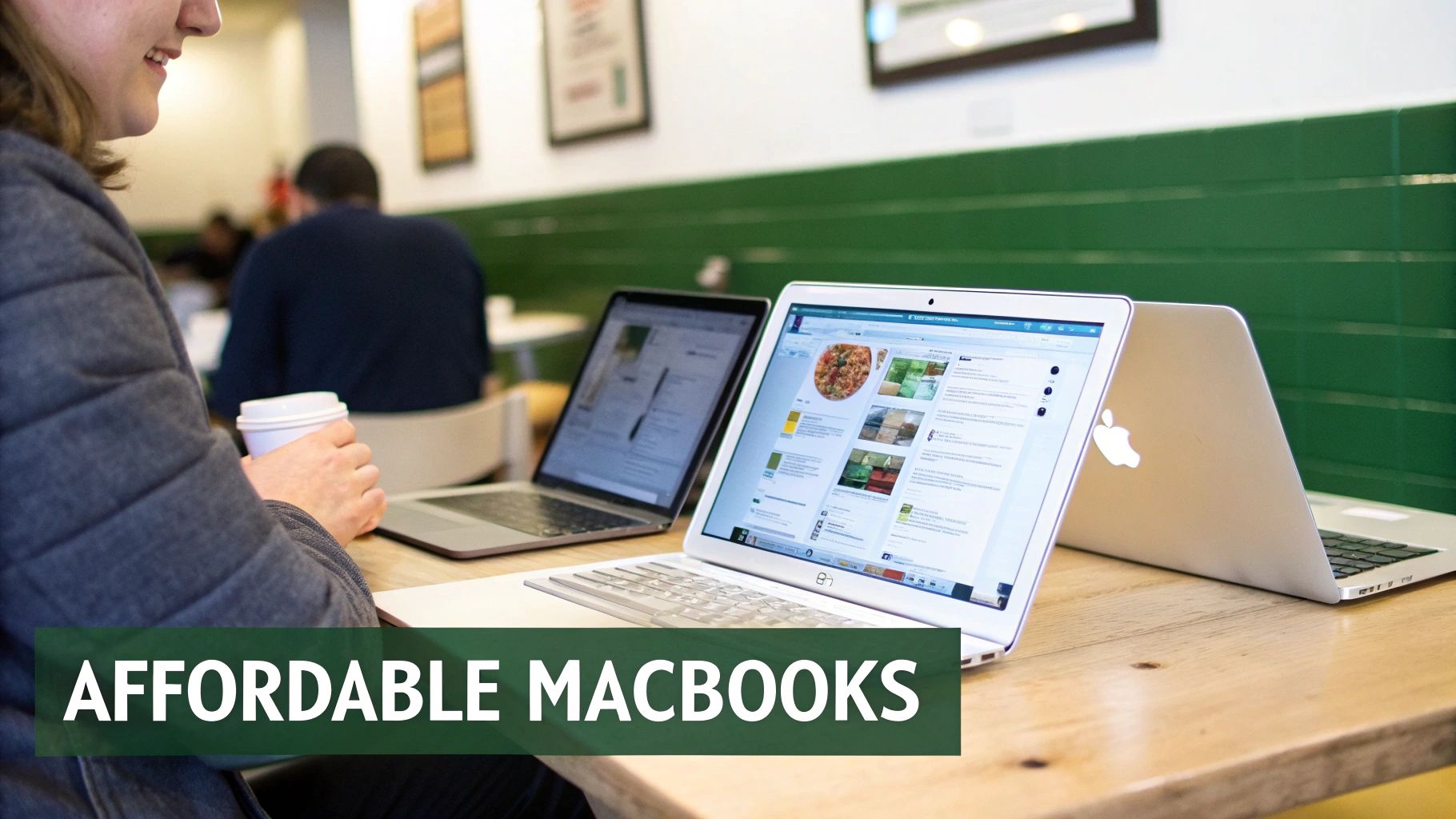 A person using a MacBook in a bright, modern setting.