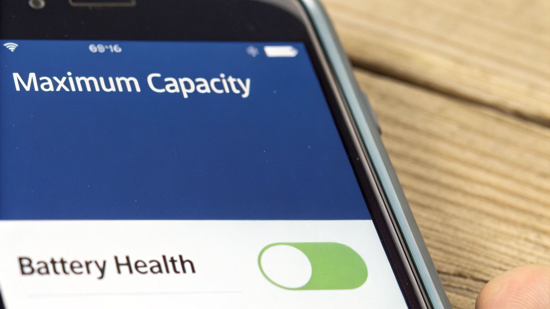 A smartphone screen displays battery health information including 'Maximum Capacity' with a green toggle.