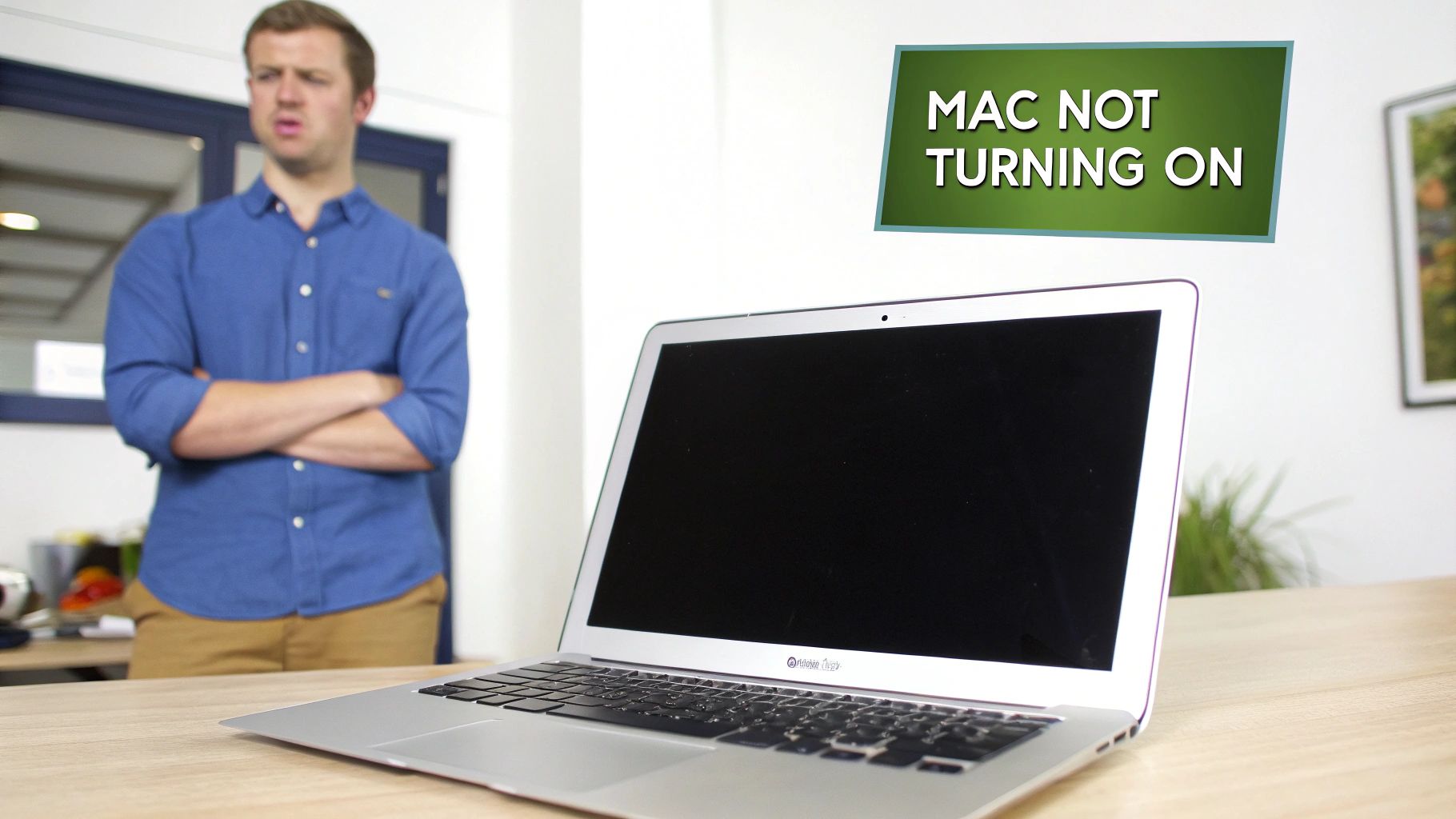 MacBook Air laptop with black screen not turning on with frustrated man in background