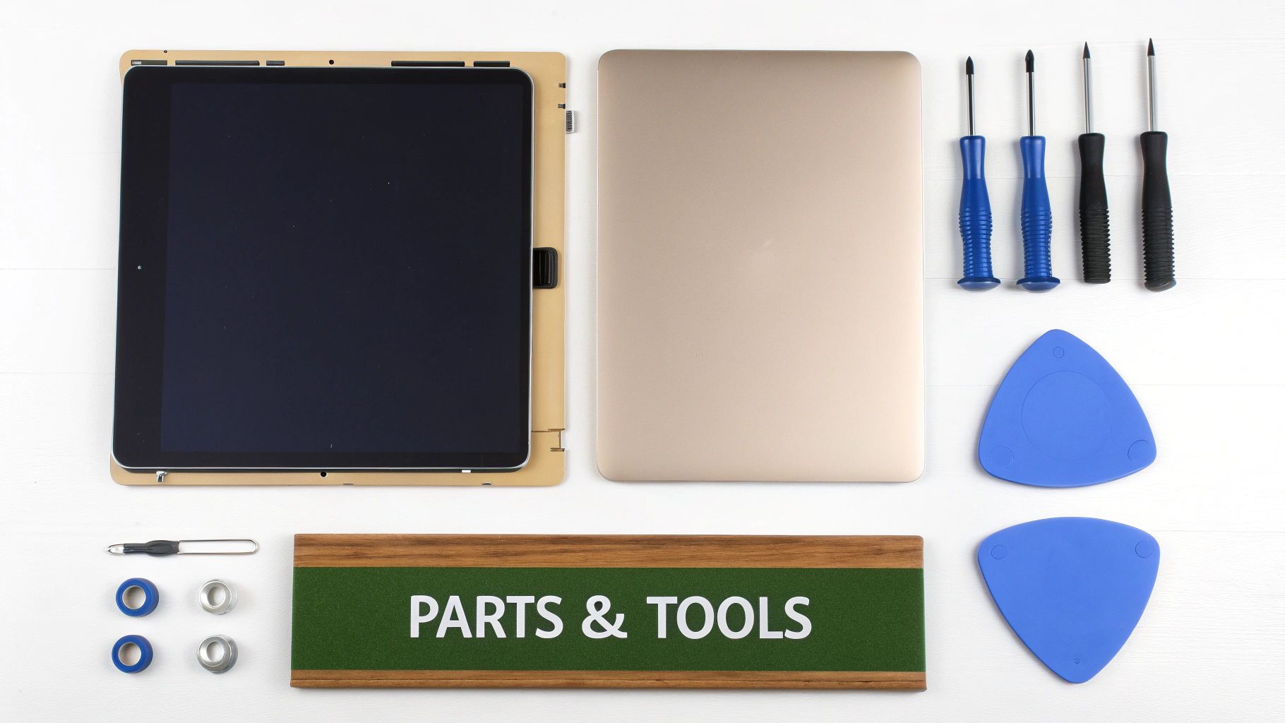 Flat lay of electronics repair tools and parts, including a disassembled tablet, laptop components, and various screwdrivers.
