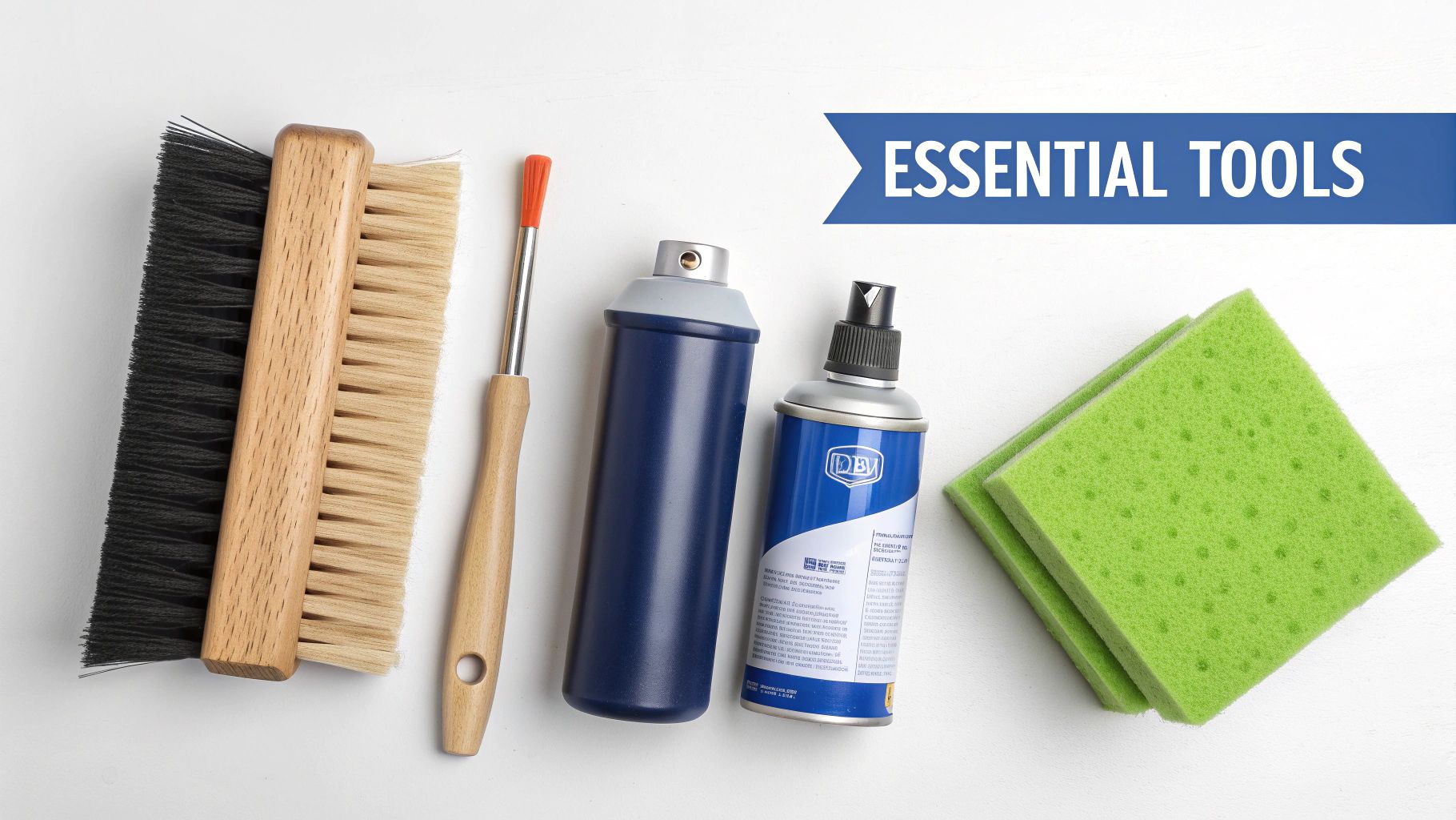 A flat lay of various essential cleaning tools including brushes, spray cans, and sponges on a white background.