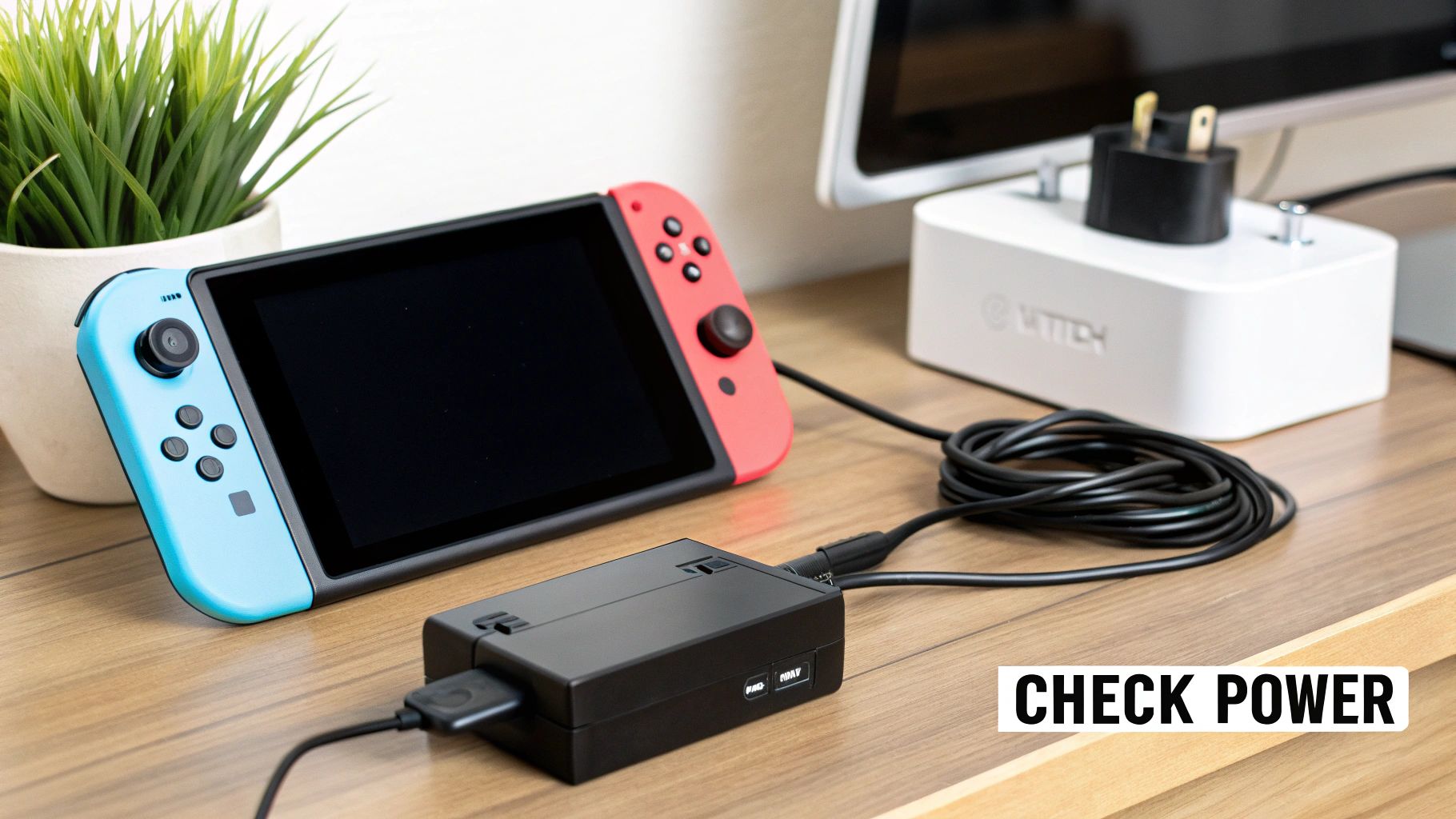 Nintendo Switch with blue and red controllers connected to power adapter on desk