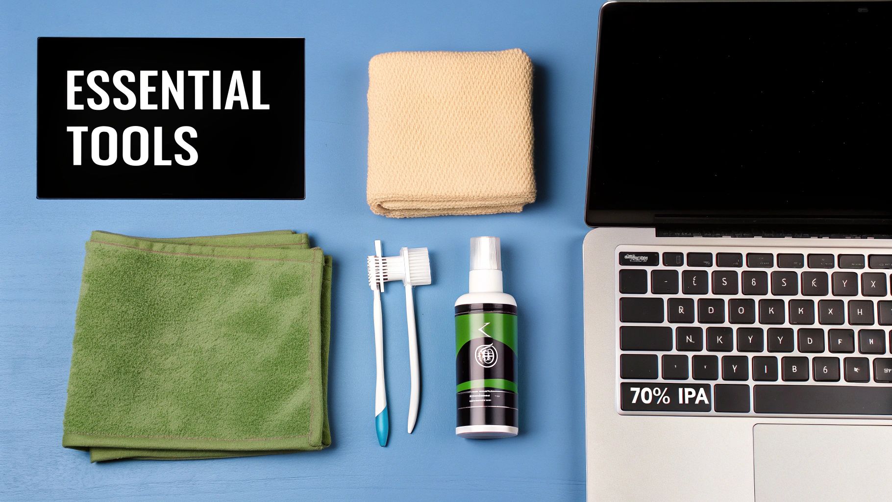 Essential tools for cleaning a laptop keyboard, including cloths, brushes, and a cleaning spray bottle.