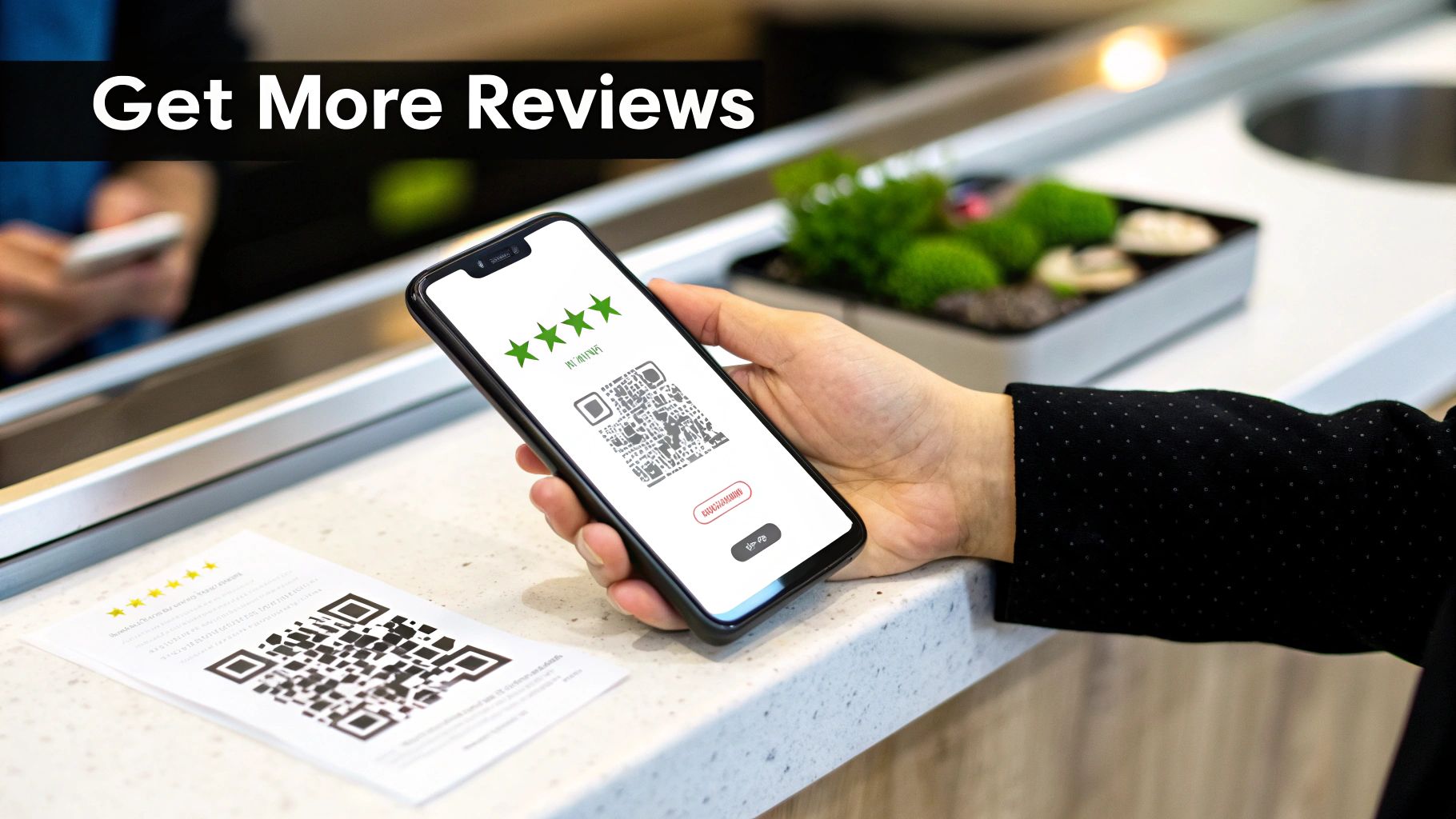 A hand holds a smartphone displaying a QR code for customer reviews, next to a printed QR code.