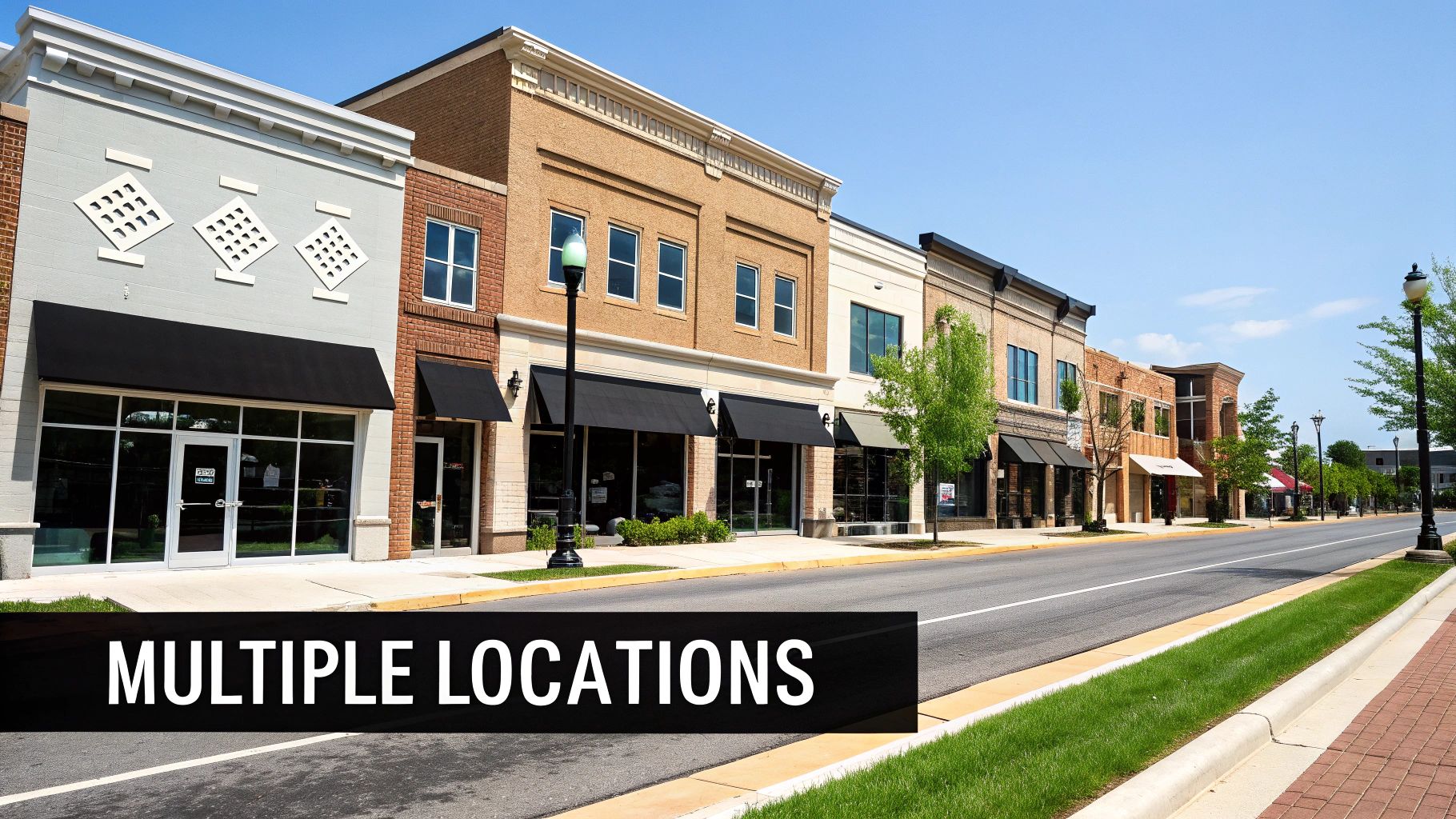 A vibrant street scene showcasing multiple storefronts and businesses along a sunny town street.