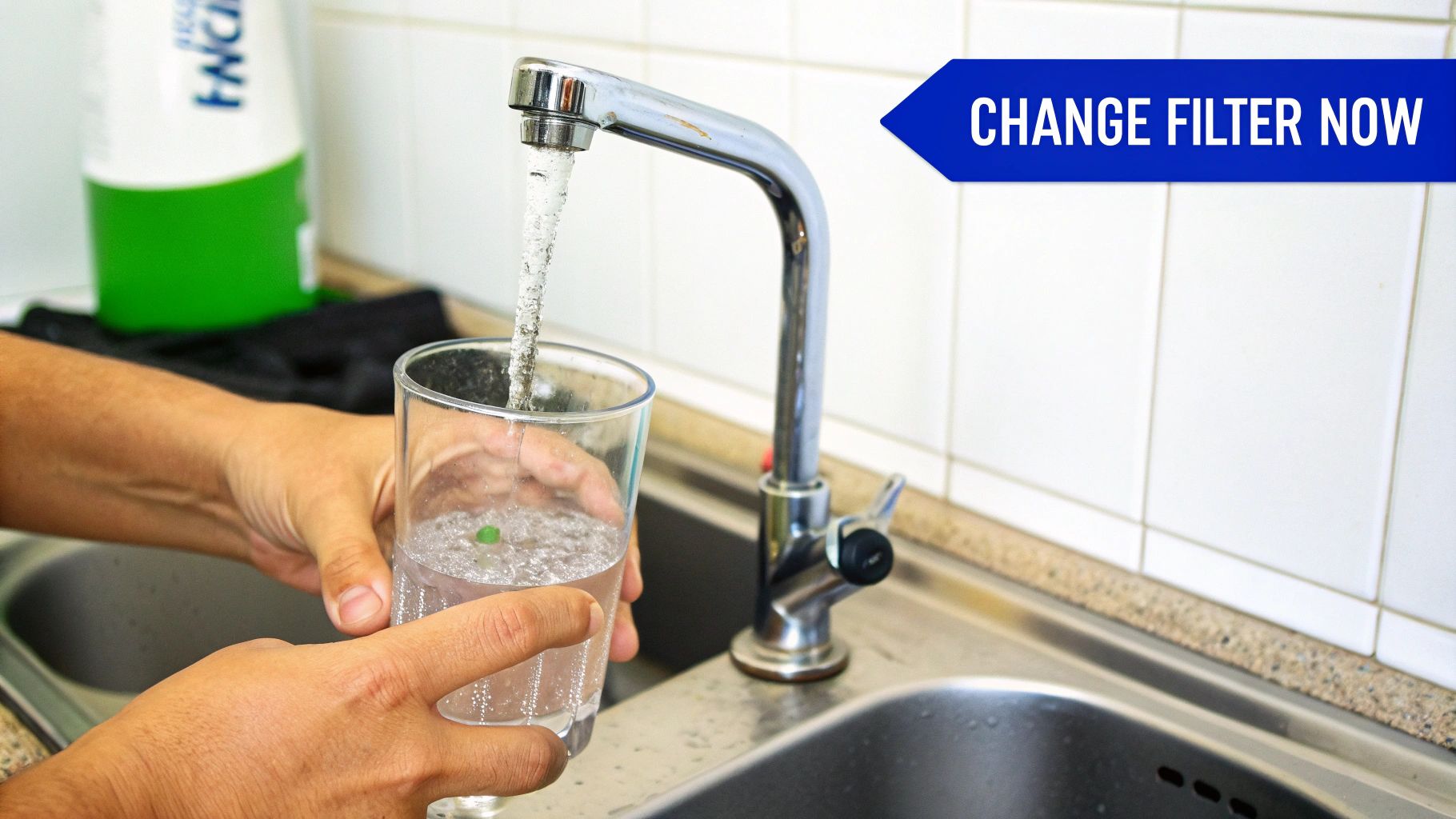 A person's hands unscrewing a water filter housing to replace the cartridge.