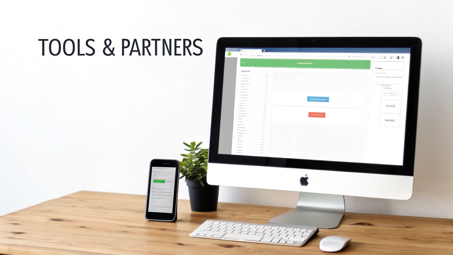 A modern workspace with an Apple iMac displaying a web application, an iPhone, keyboard, and mouse on a wooden desk.