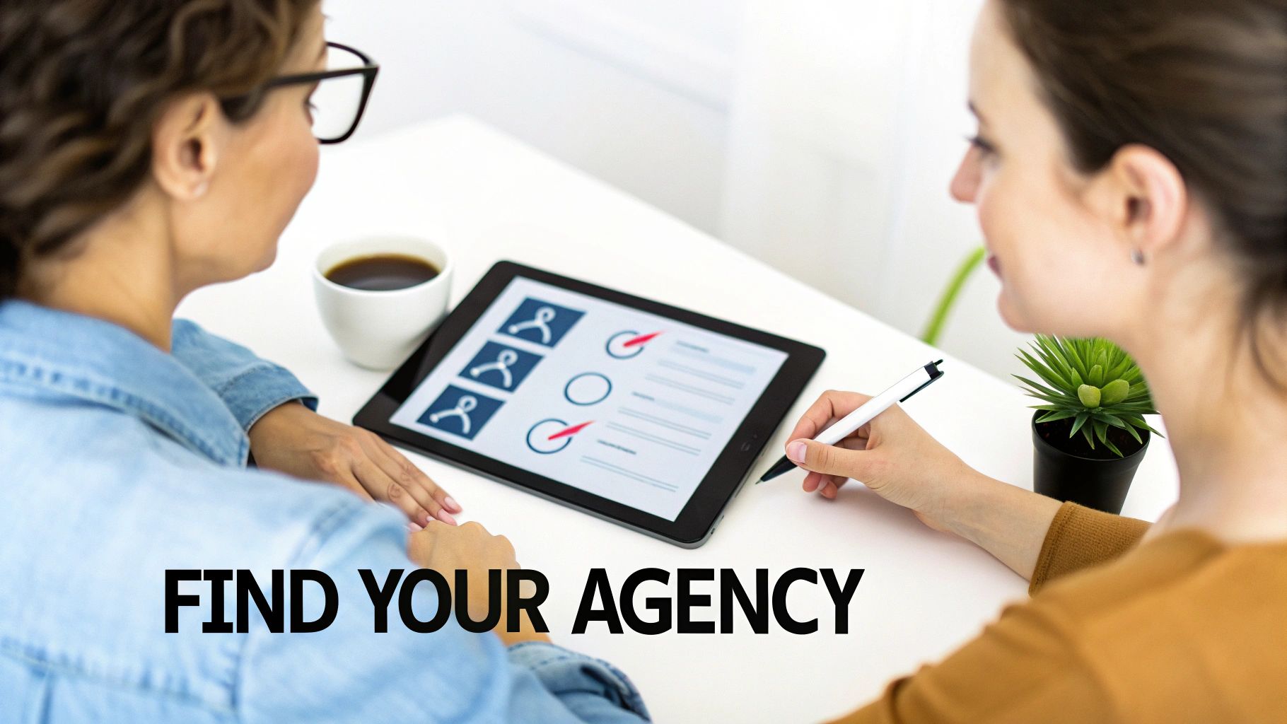 Two women reviewing agency options on a tablet screen, one holding a stylus, discussing choices.