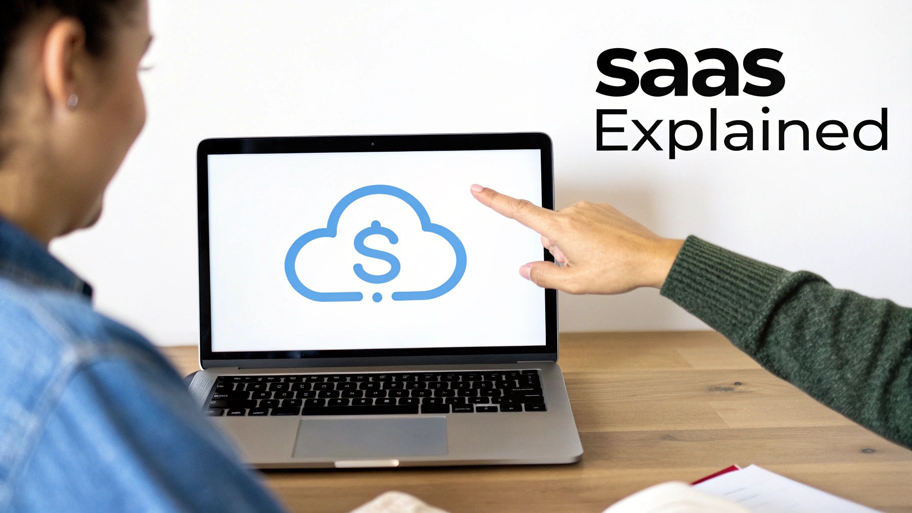 A hand points to a laptop screen showing a cloud with dollar sign icon, next to 'saas Explained' text.