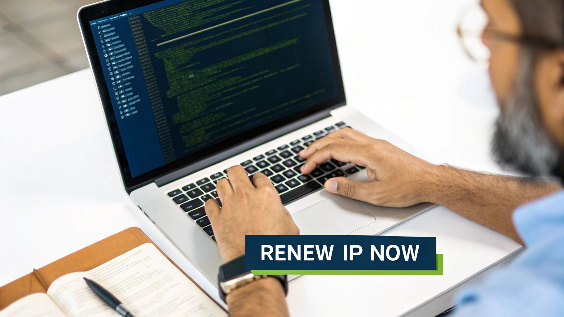 Close-up of a person typing on a laptop with green code, a 'RENEW IP NOW' banner, and a notebook.