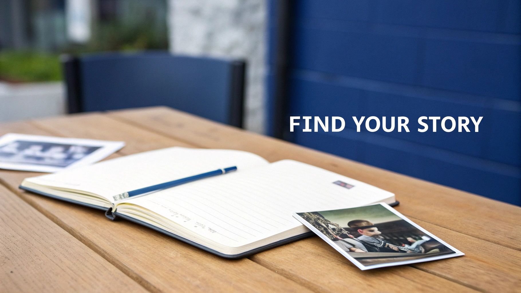 An open notebook and pencil on a wooden table, with old photographs and the text "FIND YOUR STORY."