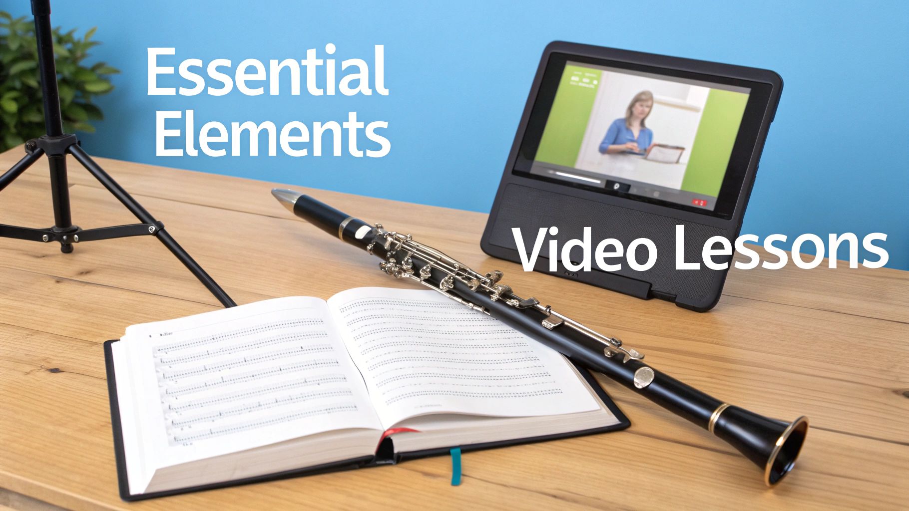 A clarinet, open music book, and tablet showing a video lesson on a wooden table.