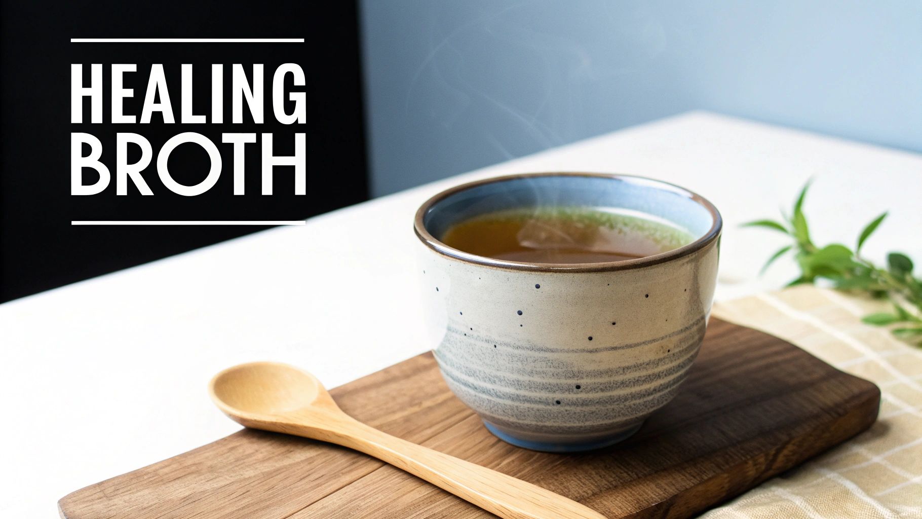Steaming cup of healing broth on a wooden board with a wooden spoon and fresh herbs.