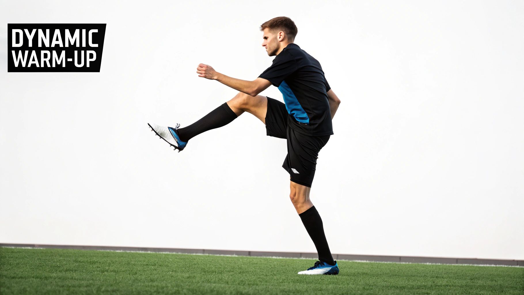 A male soccer player performs a high leg kick on a green turf, part of a dynamic warm-up.