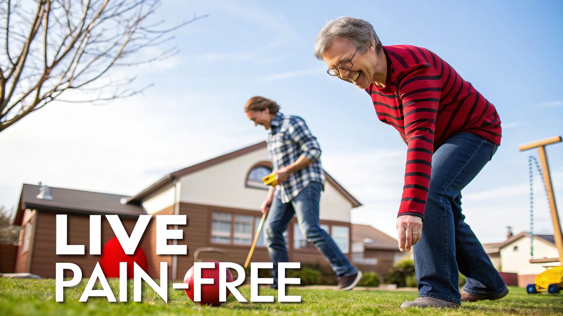 An older woman smiling and bending to pick up a croquet ball in a sunny backyard.