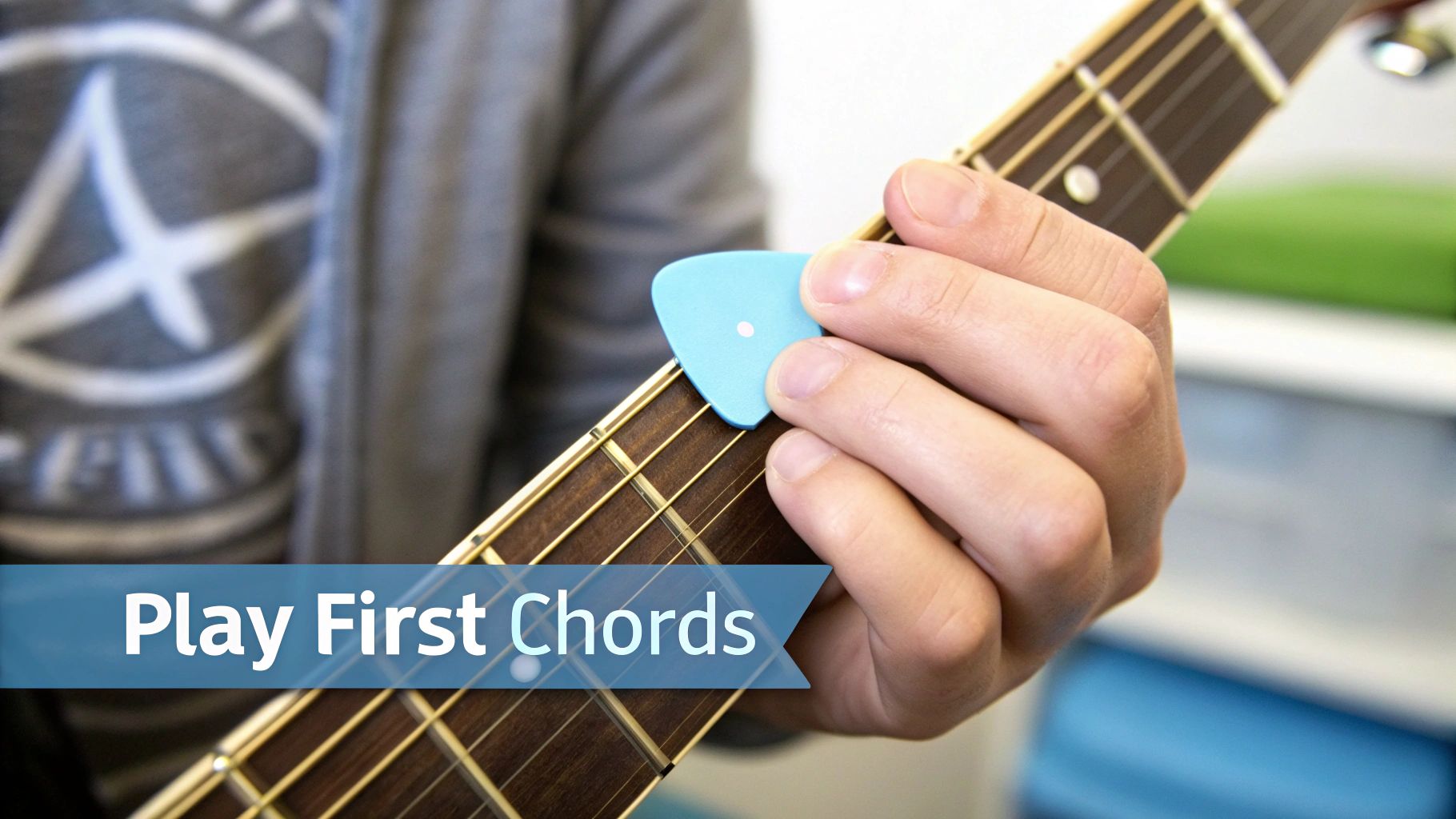 A close-up of a person's hands holding a guitar with a blue pick and 'Play First Chords' text.