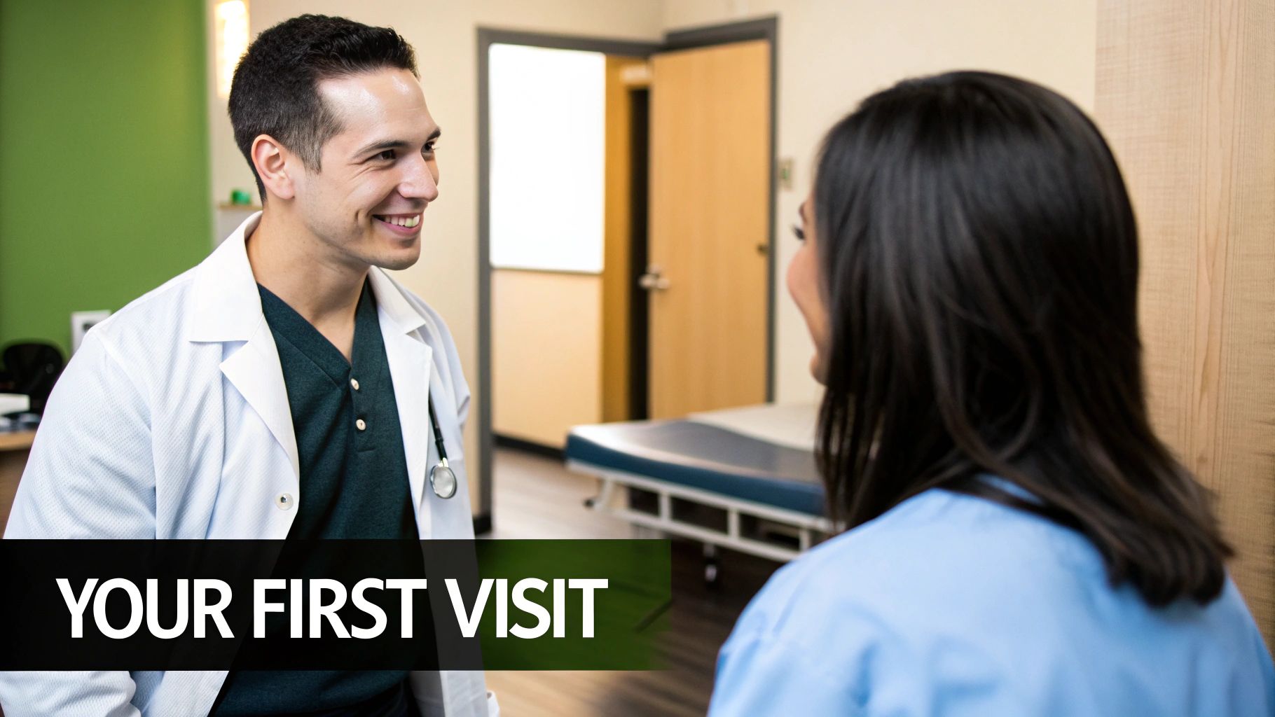 A friendly male doctor smiles while talking to a patient during her first visit.
