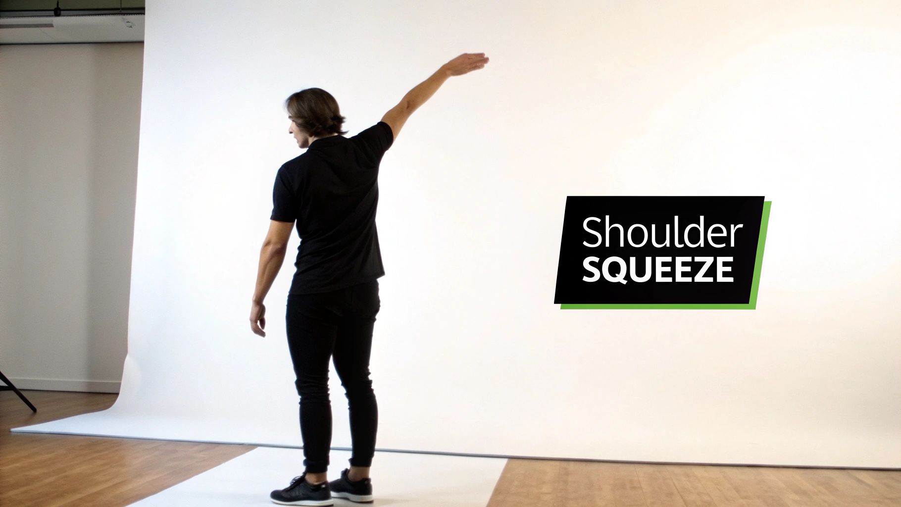 Hershey Family Chiropractic | Neck Pain Chiropractor in Hershey, PA: Your Guide to Lasting Relief A person viewed from the back performing a shoulder squeeze exercise with one arm extended.