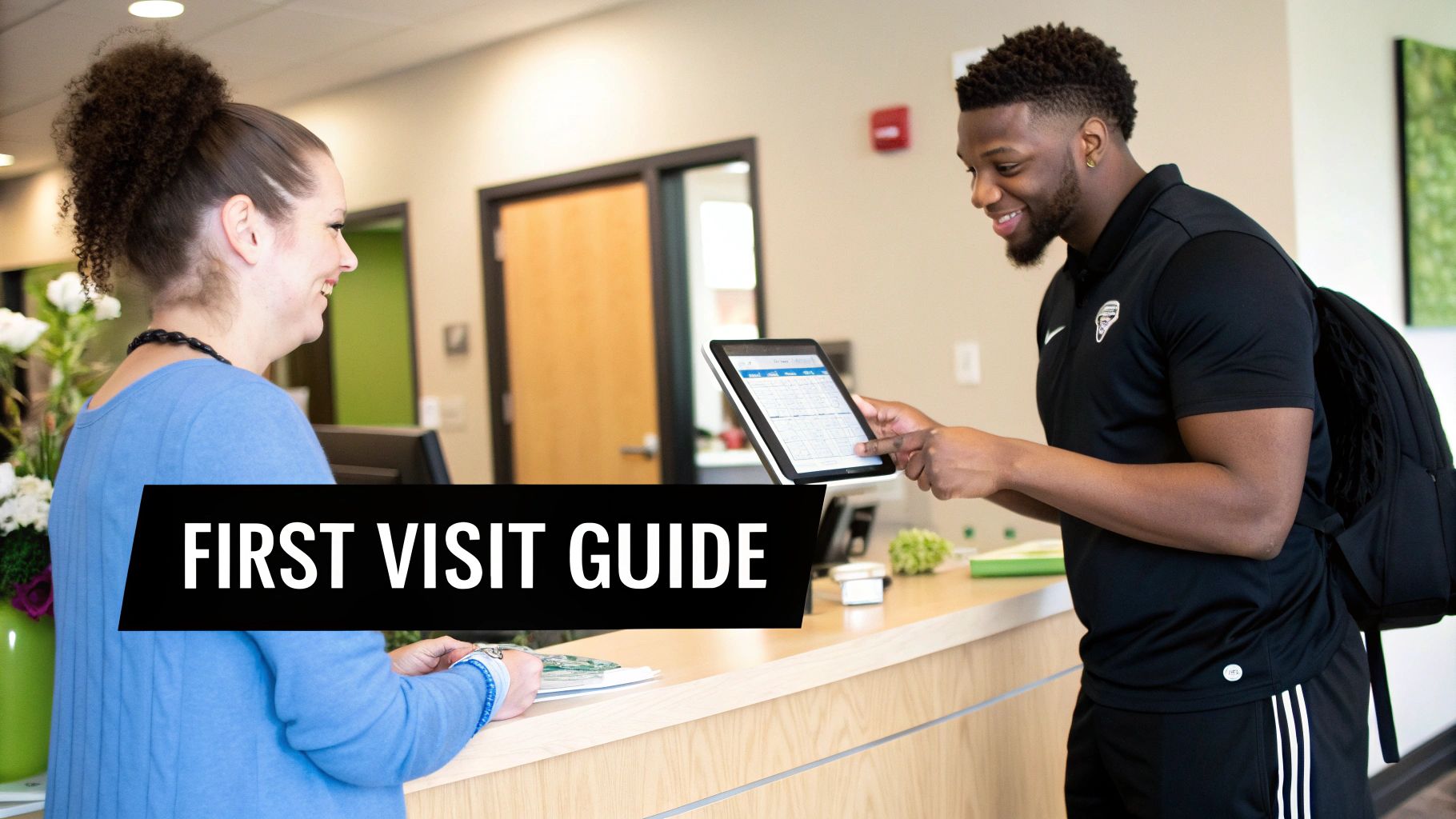A man uses a tablet at a reception desk while a woman smiles. Text: FIRST VISIT GUIDE.