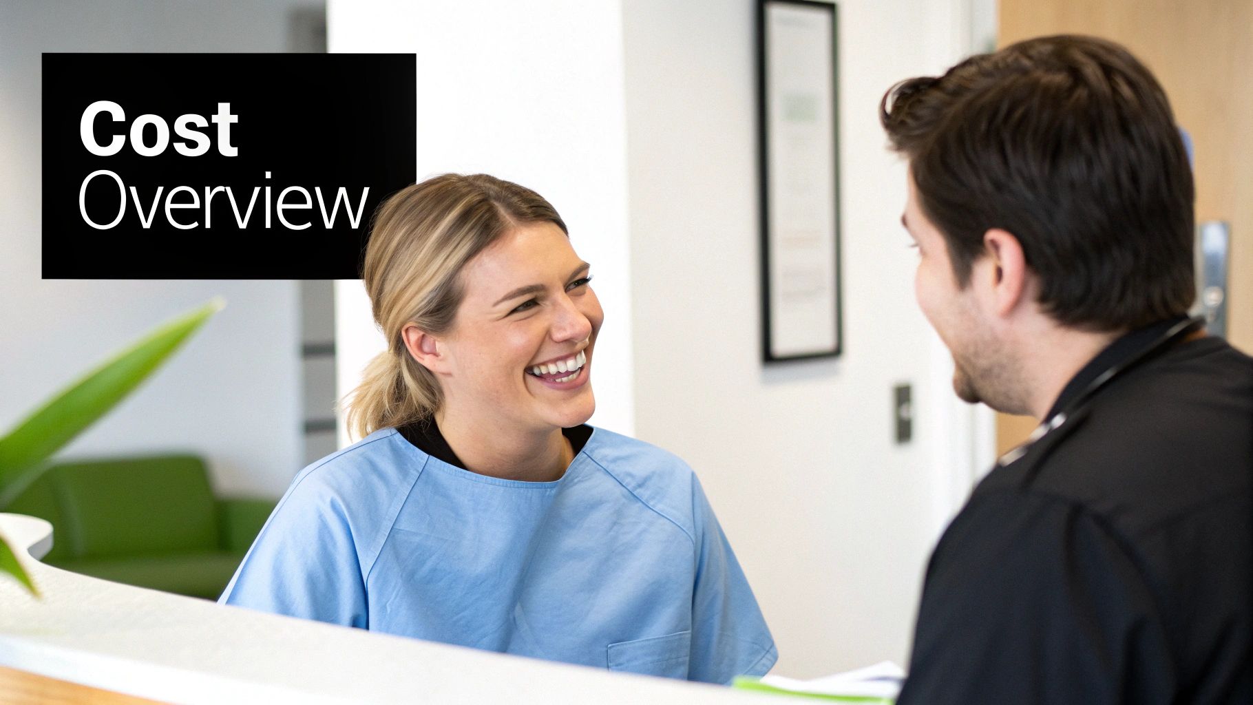 Smiling woman in medical scrubs talks to a man at a clinic reception with a 'Cost Overview' sign.