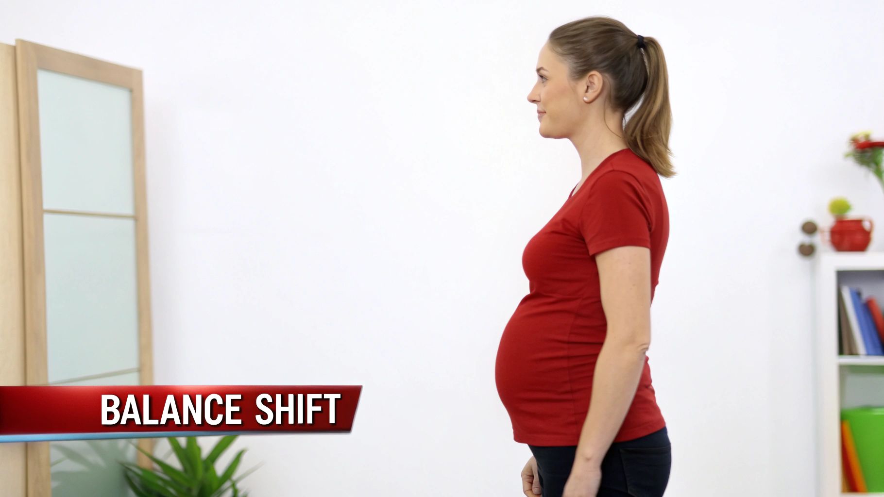 Side profile of a pregnant woman in a red shirt, demonstrating the natural balance shift.