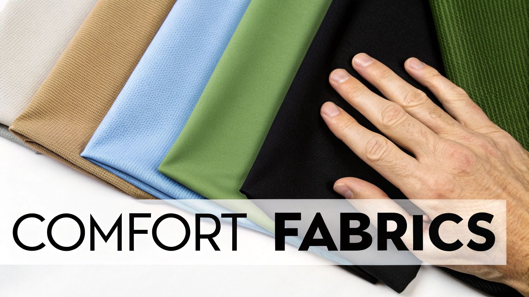 A close-up of a hand gently touching several folded pieces of comfortable, multicolored fabrics.