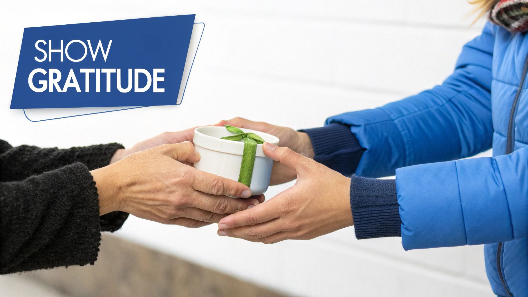 Two people exchanging a small white gift box with a green ribbon, conveying gratitude.