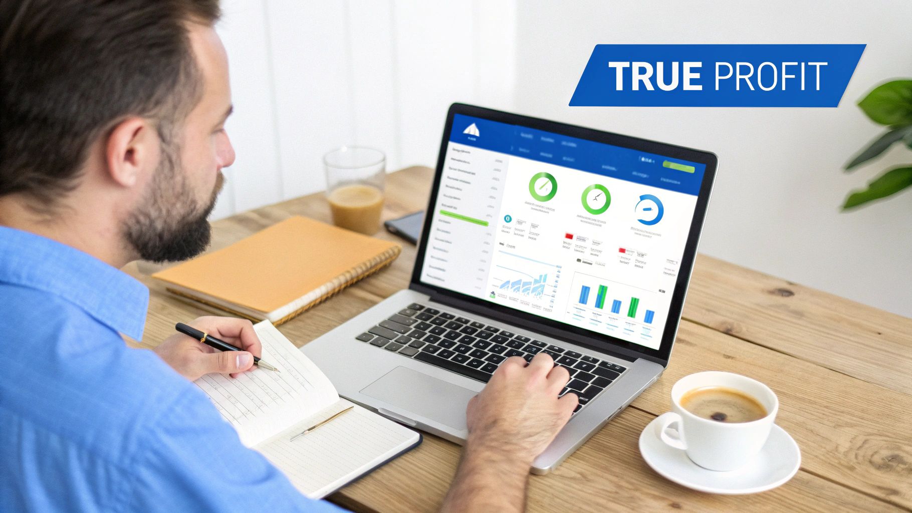 Bearded man reviewing profit data on a laptop and taking notes at a wooden desk.