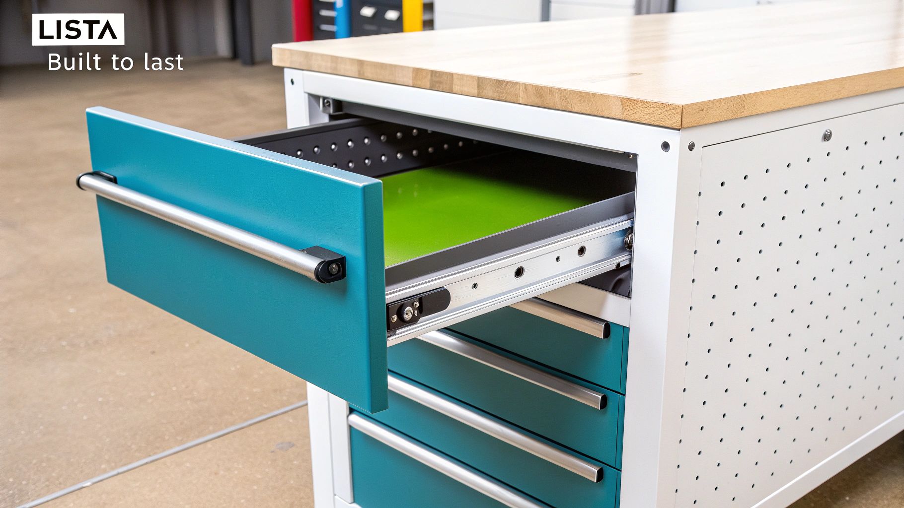 The Ultimate Guide to Lista Workshop Storage 3 Lista workshop cabinet with a solid wood top and multiple teal storage drawers, one open.