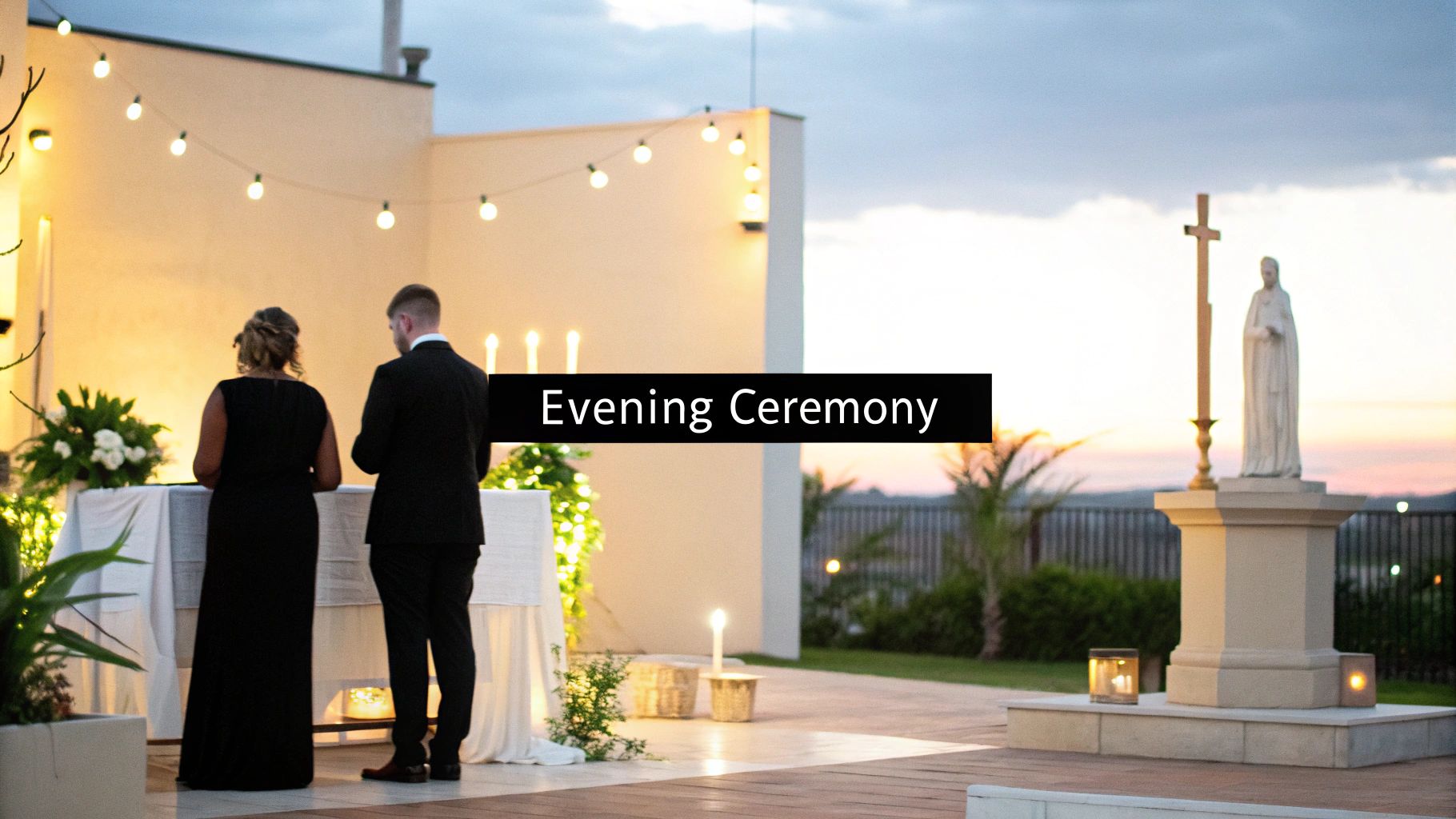 An outdoor evening ceremony shows a couple at an altar, string lights, and a statue at sunset.