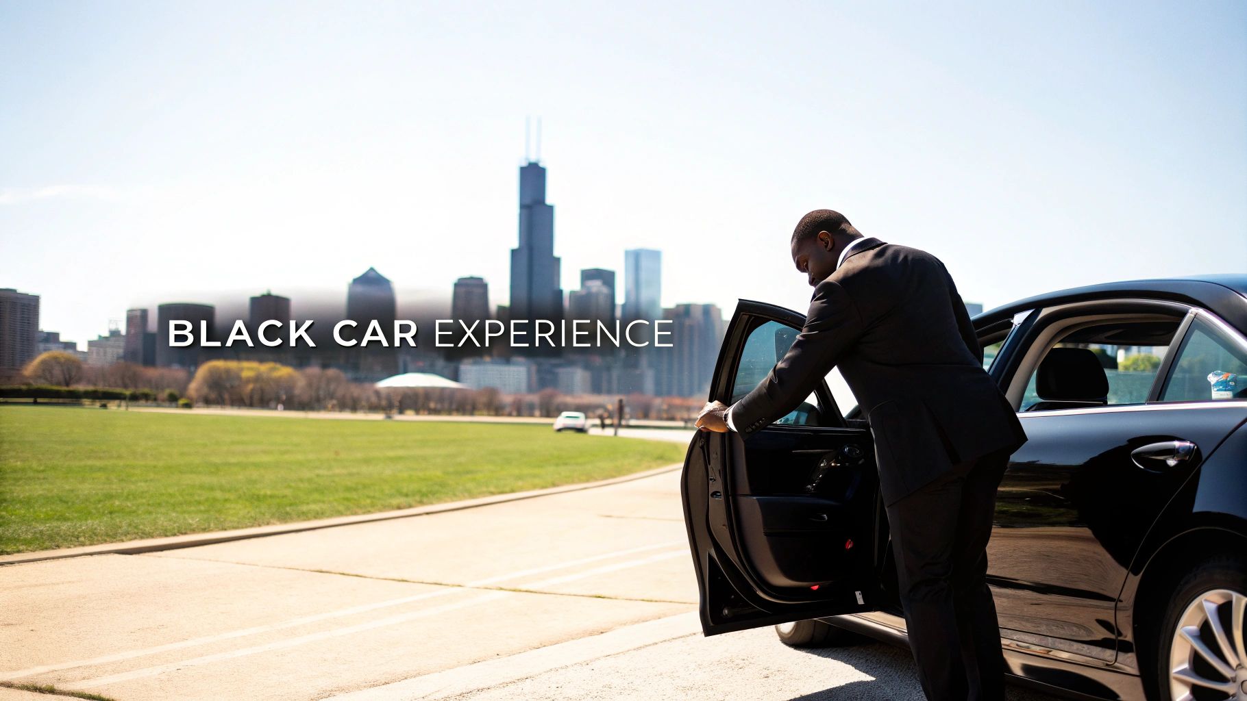 A professional chauffeur opening the door of a black luxury sedan in downtown Chicago.
