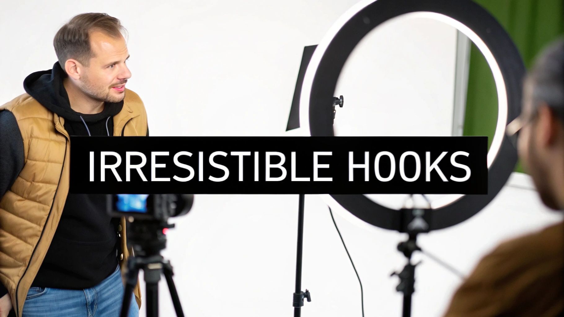 A man in a studio setting with a camera and ring light, featuring 'IRRESISTIBLE HOOKS' text overlay.