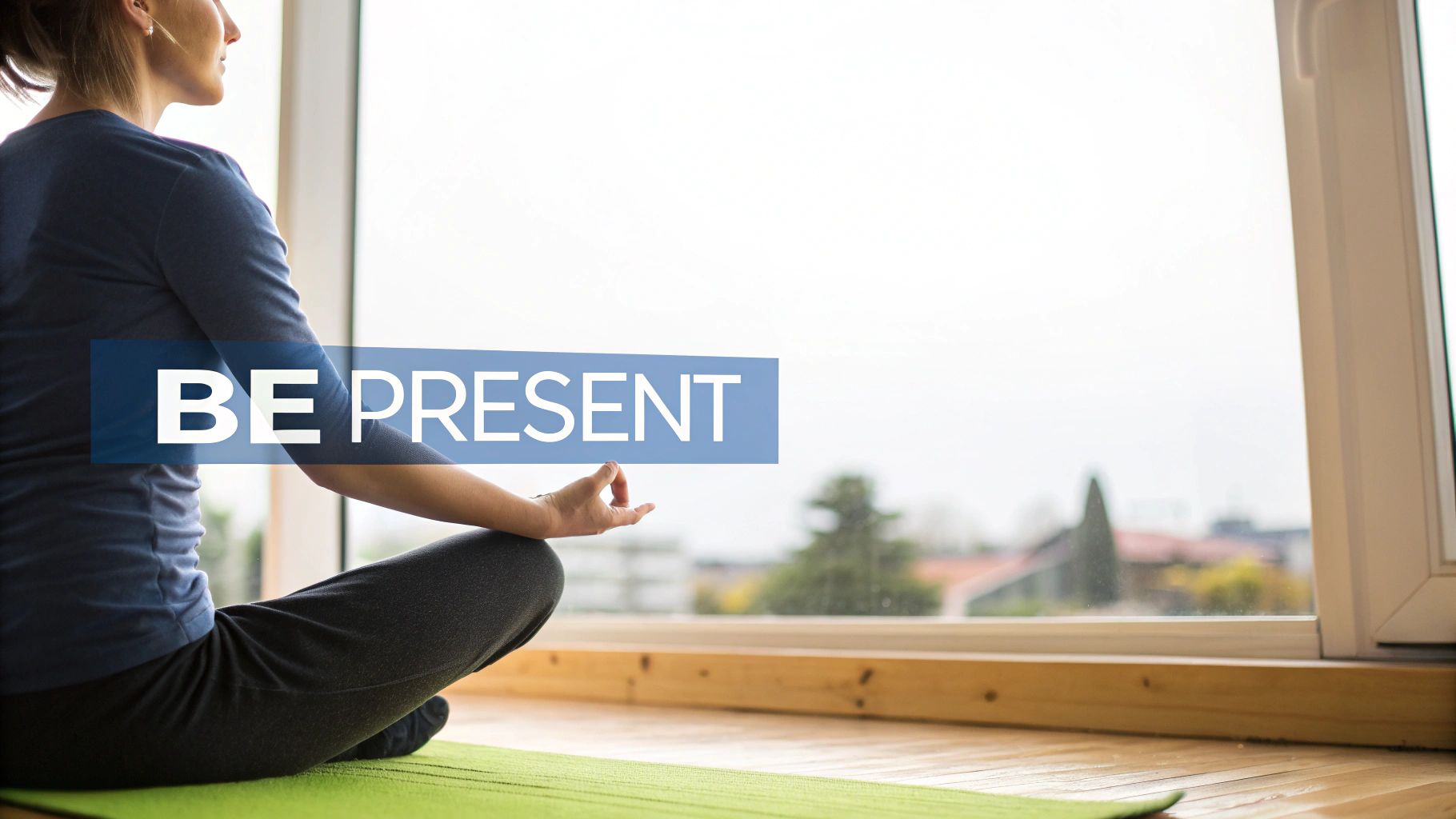 A person meditating on a yoga mat in front of a bright window, with the text 'BE PRESENT'.