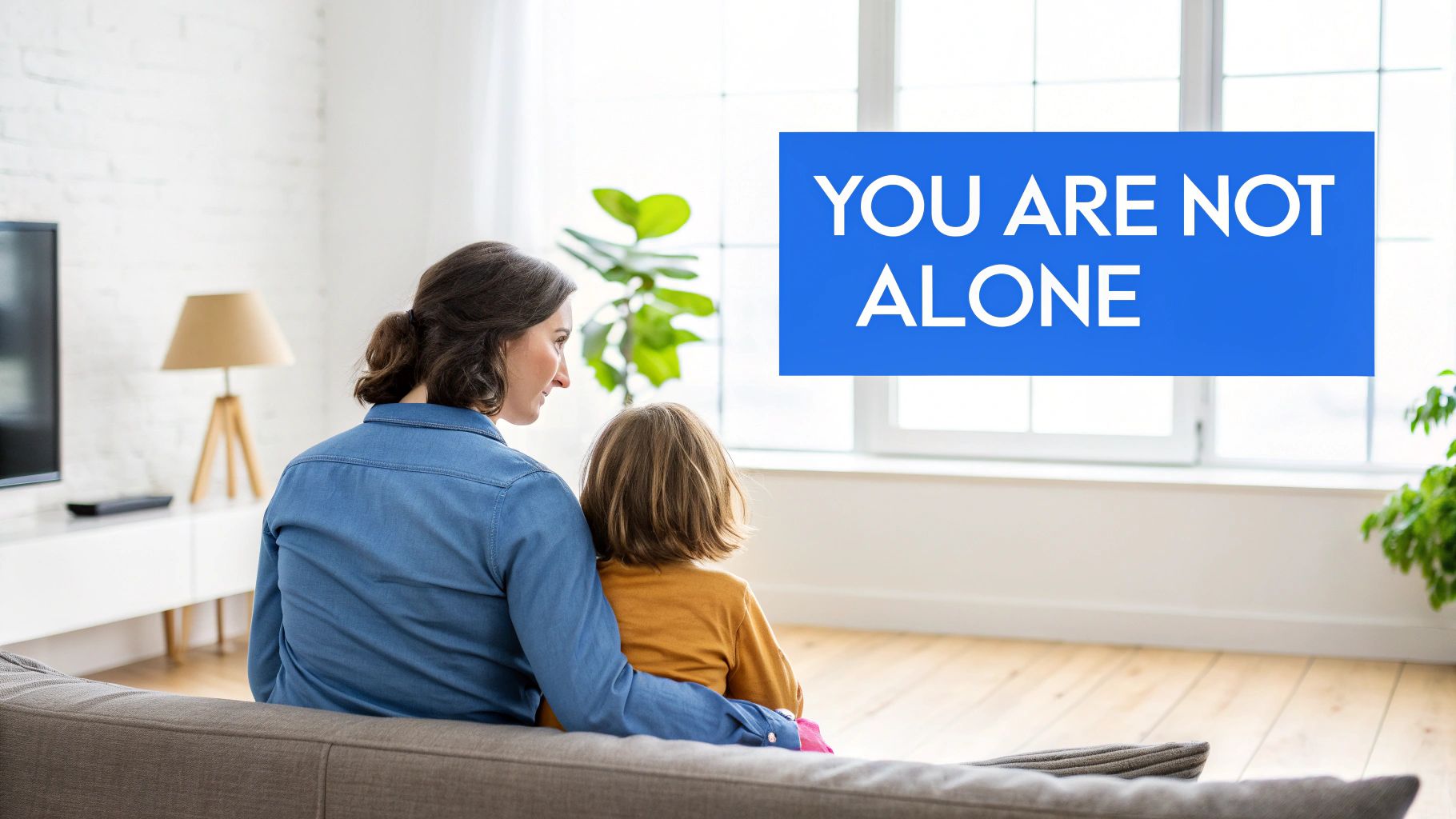 A group of diverse people sitting in a circle, offering each other support in a brightly lit room.
