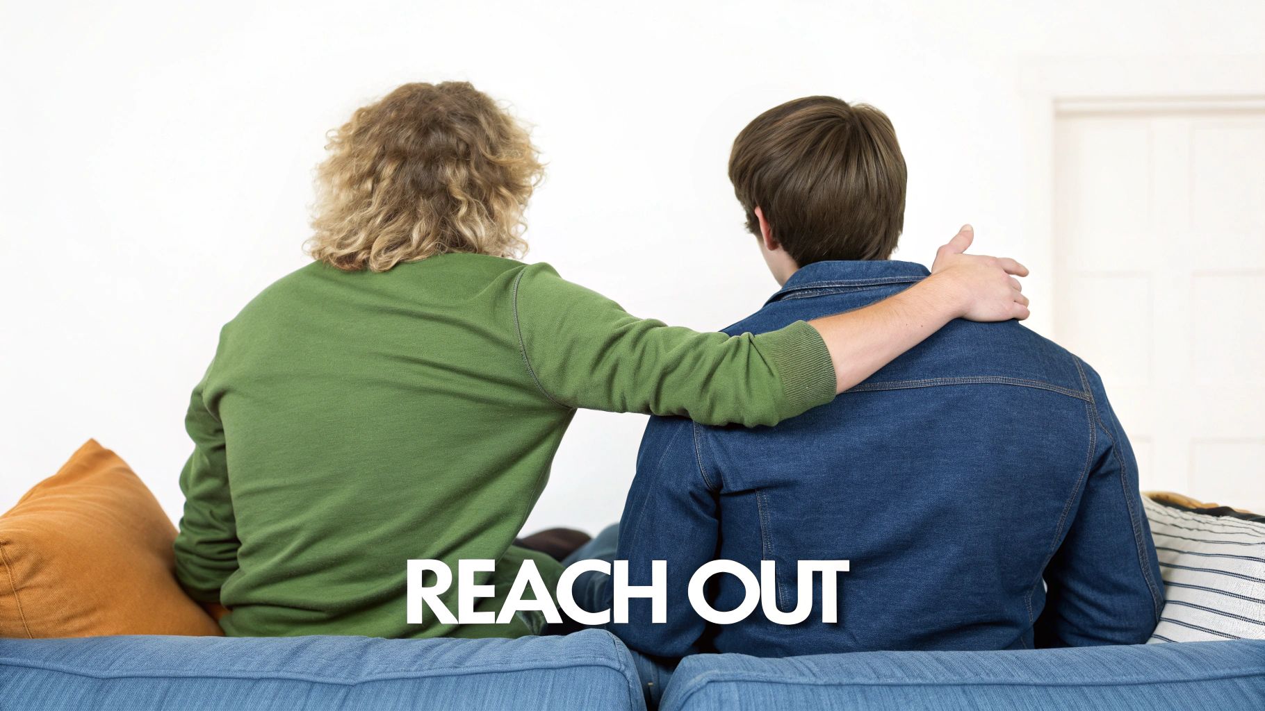 Two people are sitting on a couch, one comforting the other with an arm around them, with 'REACH OUT' text.