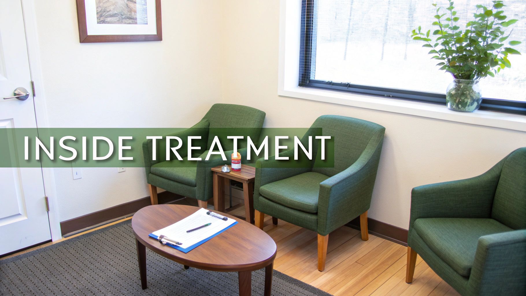 A compassionate therapist listens to a patient in a calm, well-lit room.