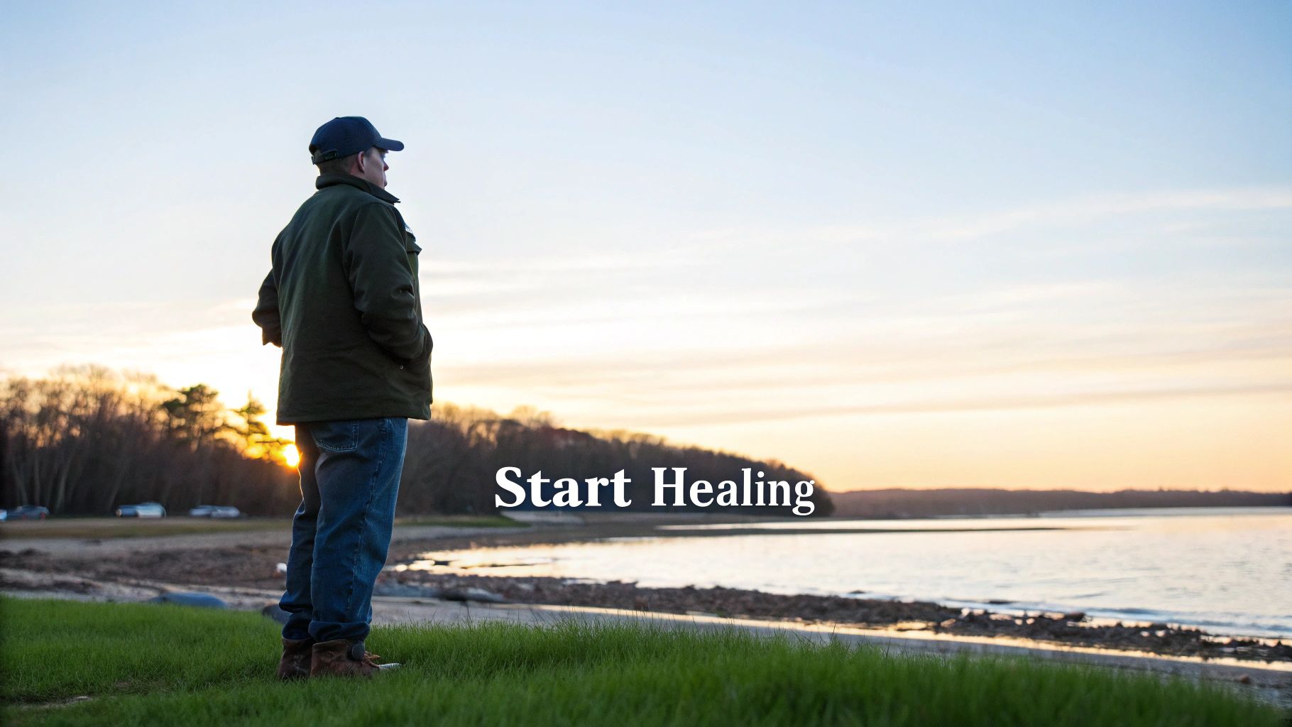 A man in a baseball cap and jacket stands on a grassy hill overlooking a lake at sunset, with text 'Start Healing'.