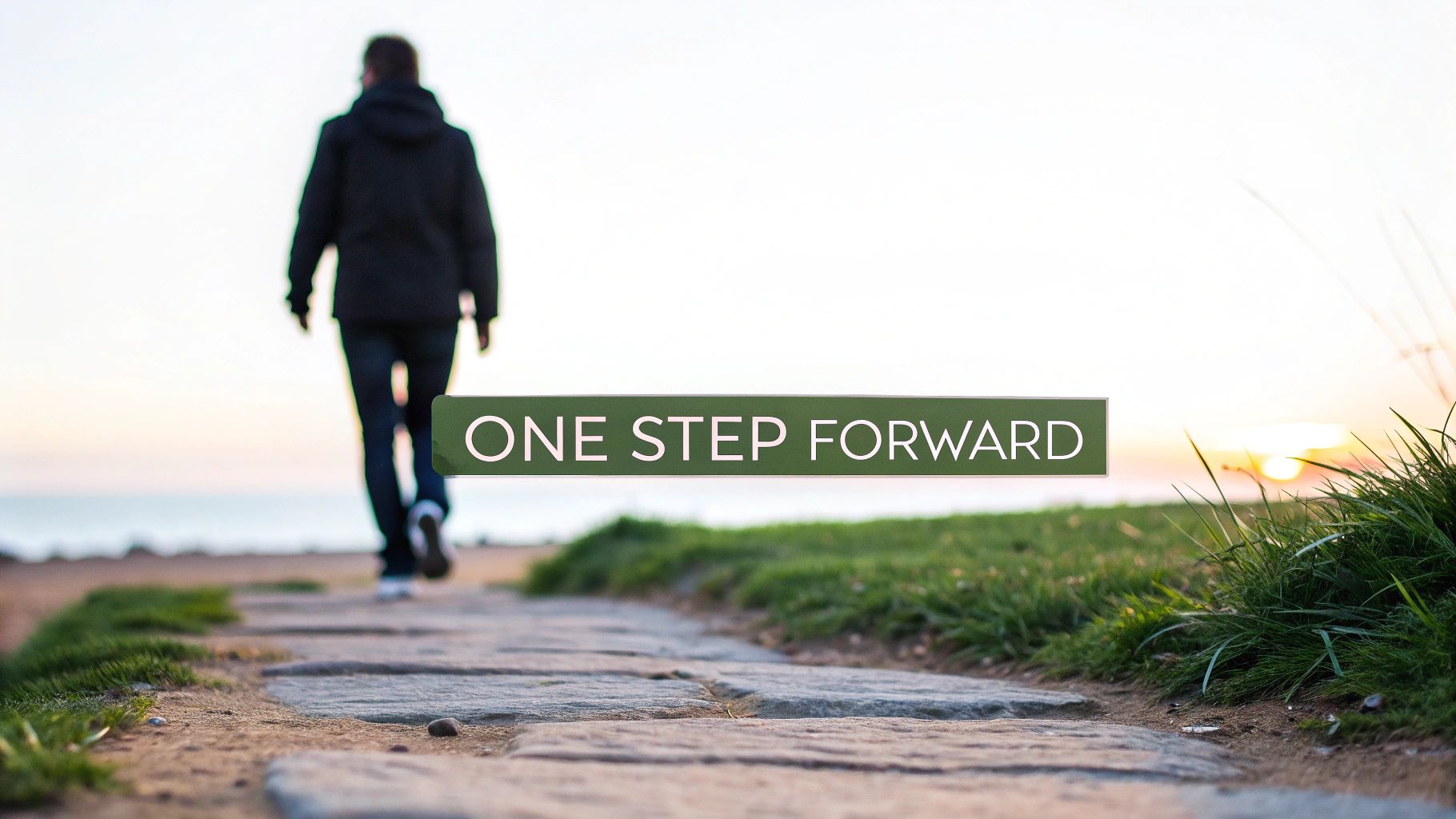 A person walks on a stone path towards a bright horizon, with the motivational text 'ONE STEP FORWARD'.