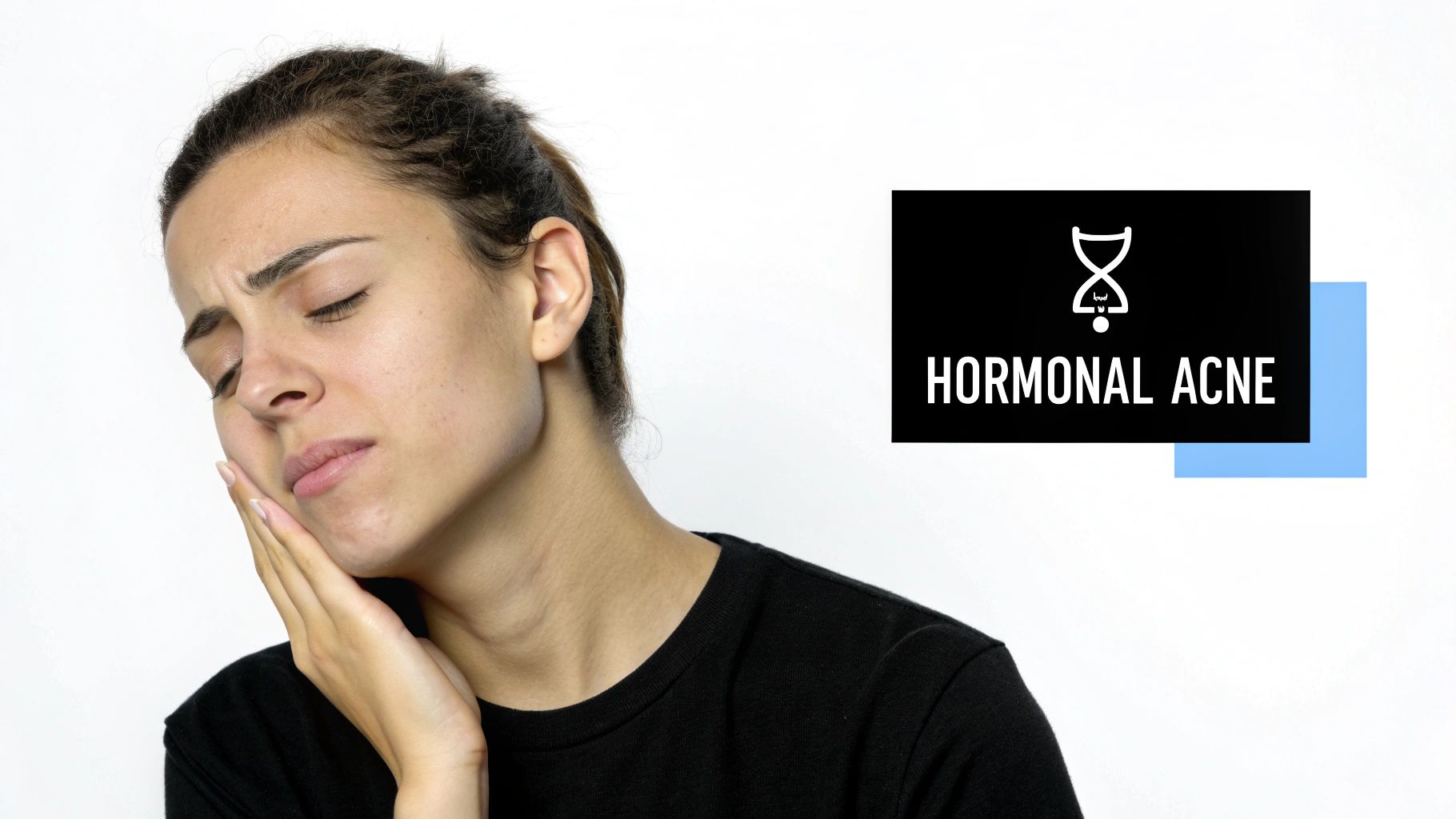 A woman examining her chin in the mirror, highlighting the hormonal acne zone.