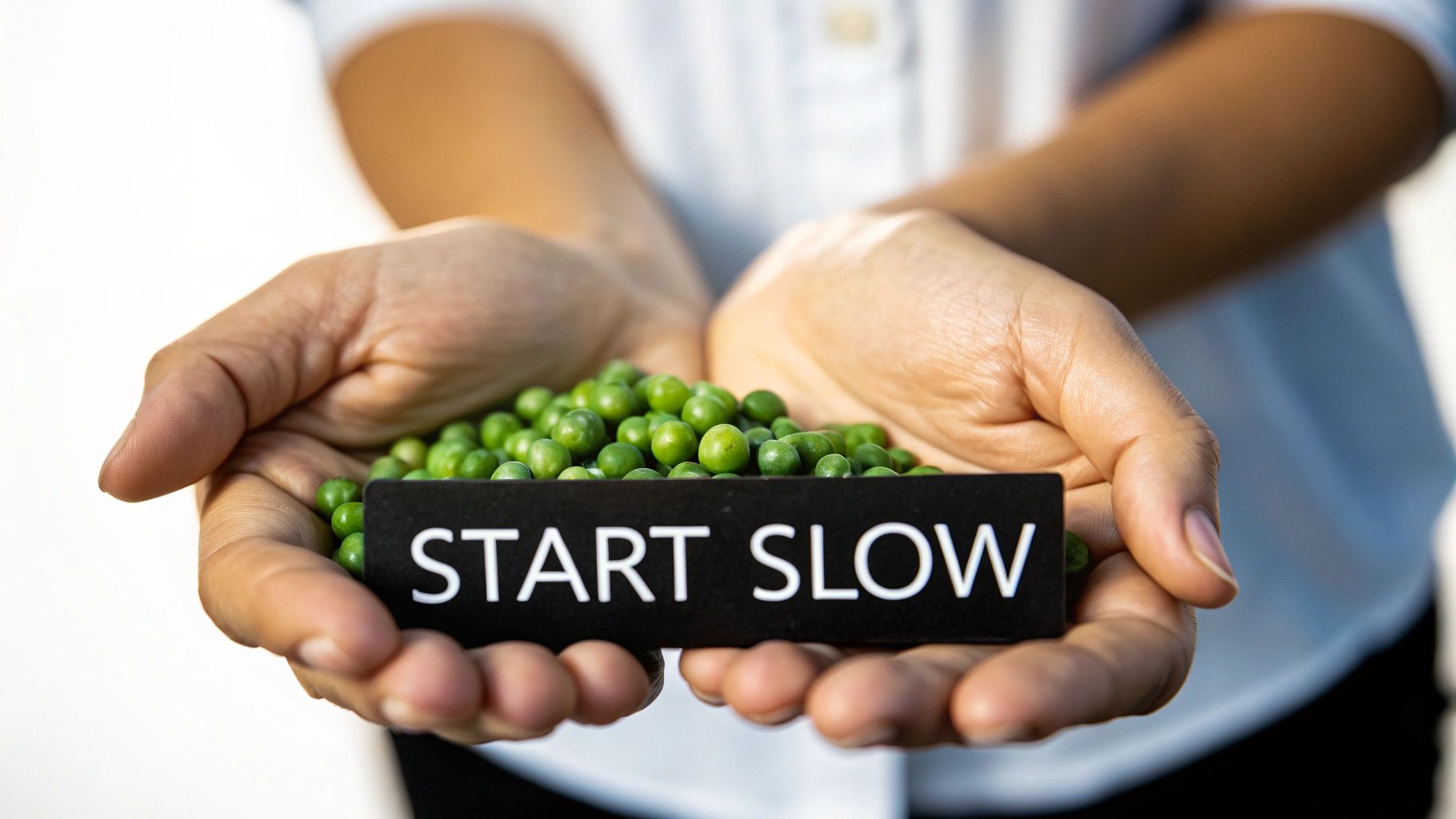 A person applying a pea-sized amount of cleanser to their fingertips with a clean, minimalist bathroom background.