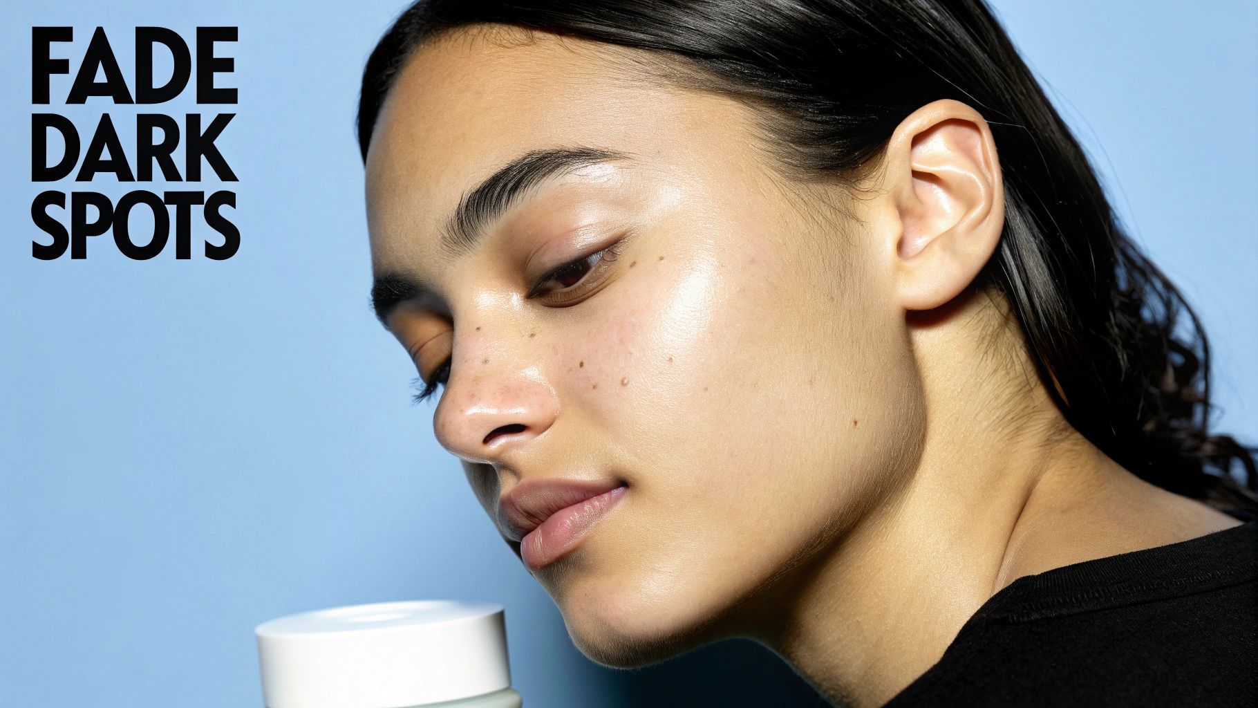A woman with dewy skin looks at a skincare jar, promoting "FADE DARK SPOTS".