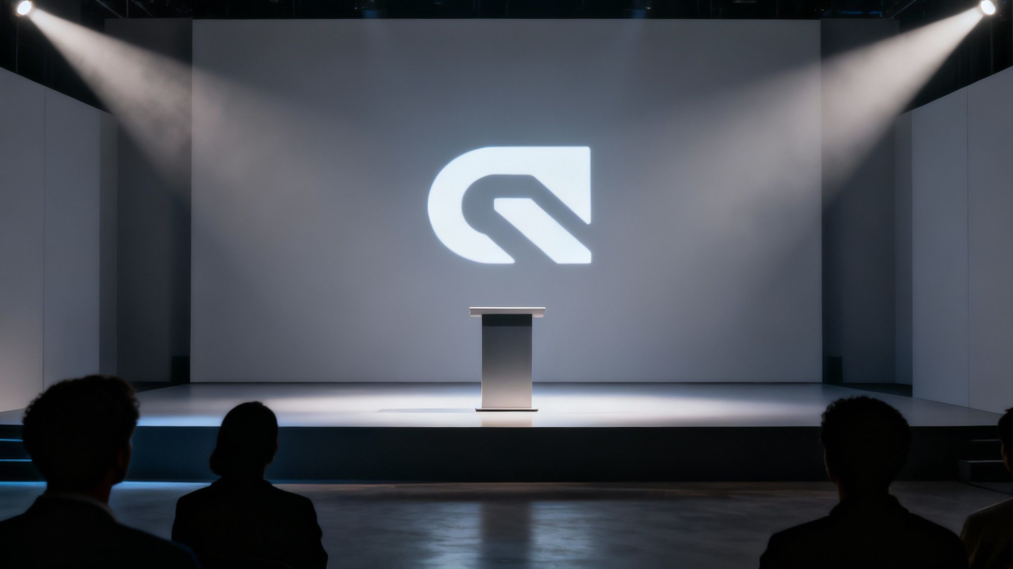 A modern presentation stage with a podium and a large screen displaying a white logo, illuminated by spotlights.