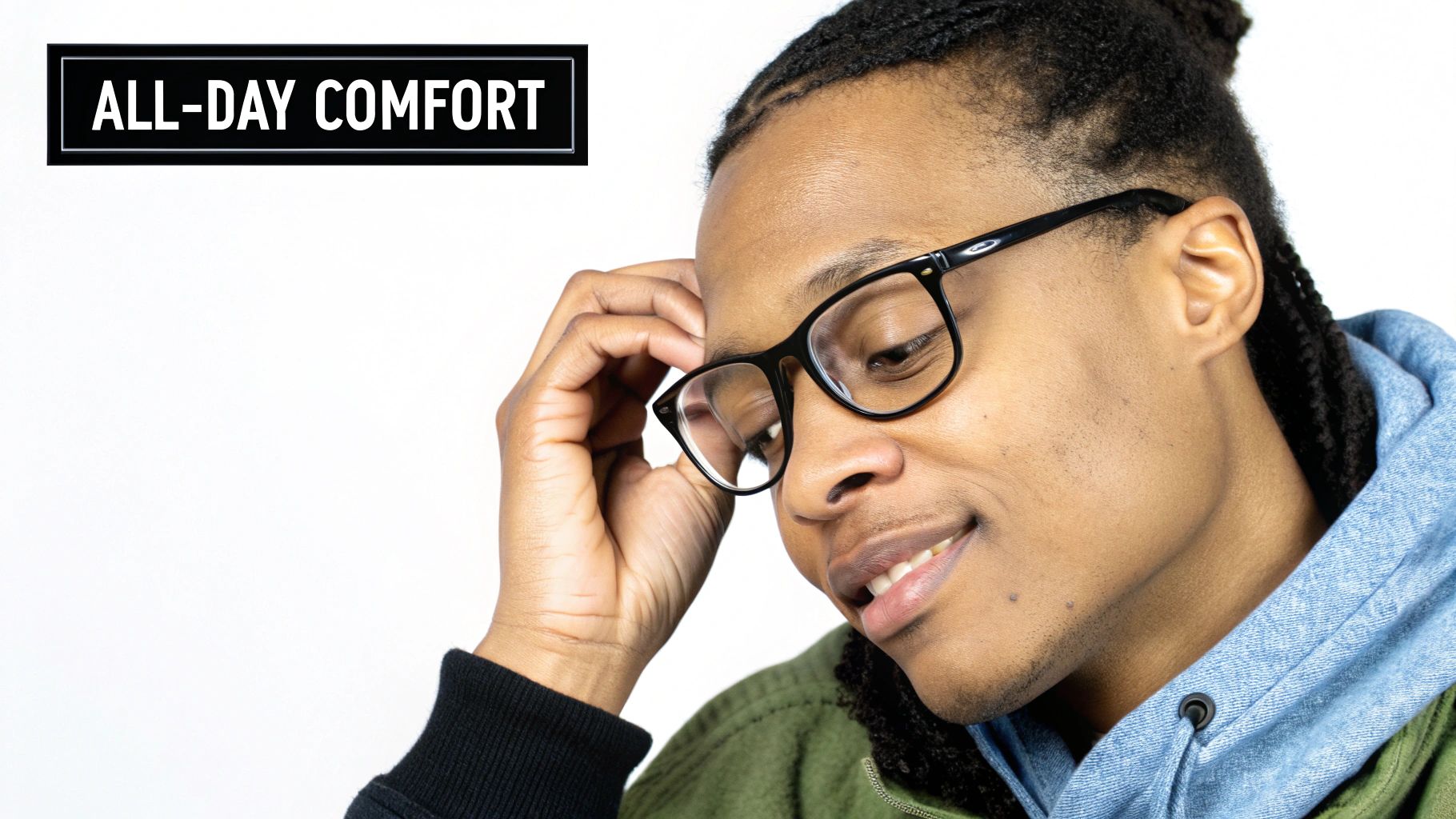 A smiling person wearing black glasses, dressed in a hoodie and jacket, with "ALL-DAY COMFORT" text.