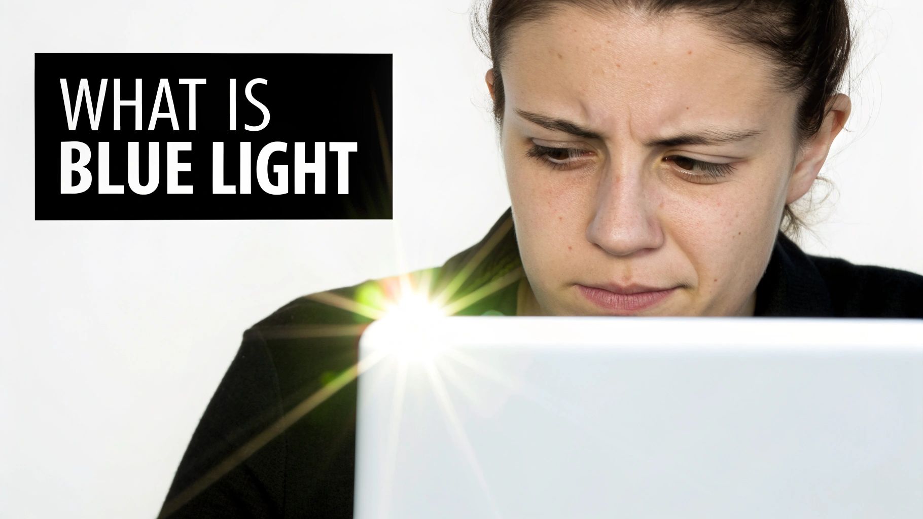 Woman wearing glasses and looking at a computer screen, illustrating blue light exposure.