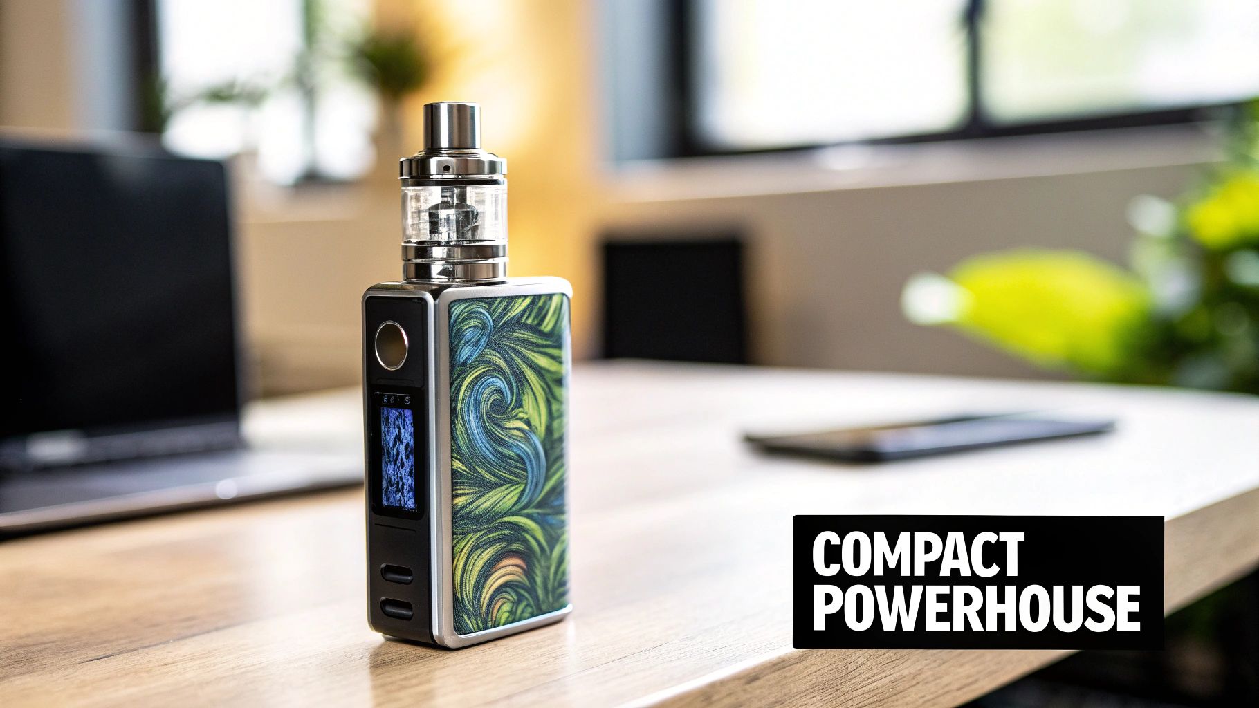 A stylish vape device with a vibrant patterned design sits on a wooden desk.